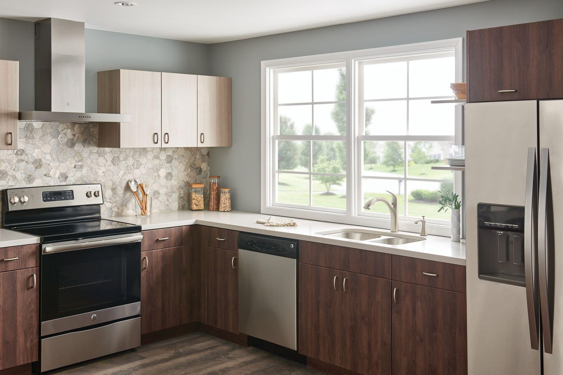 Stainless steel single-handle kitchen faucet with pullout spray head mounted above sink in modern kitchen.