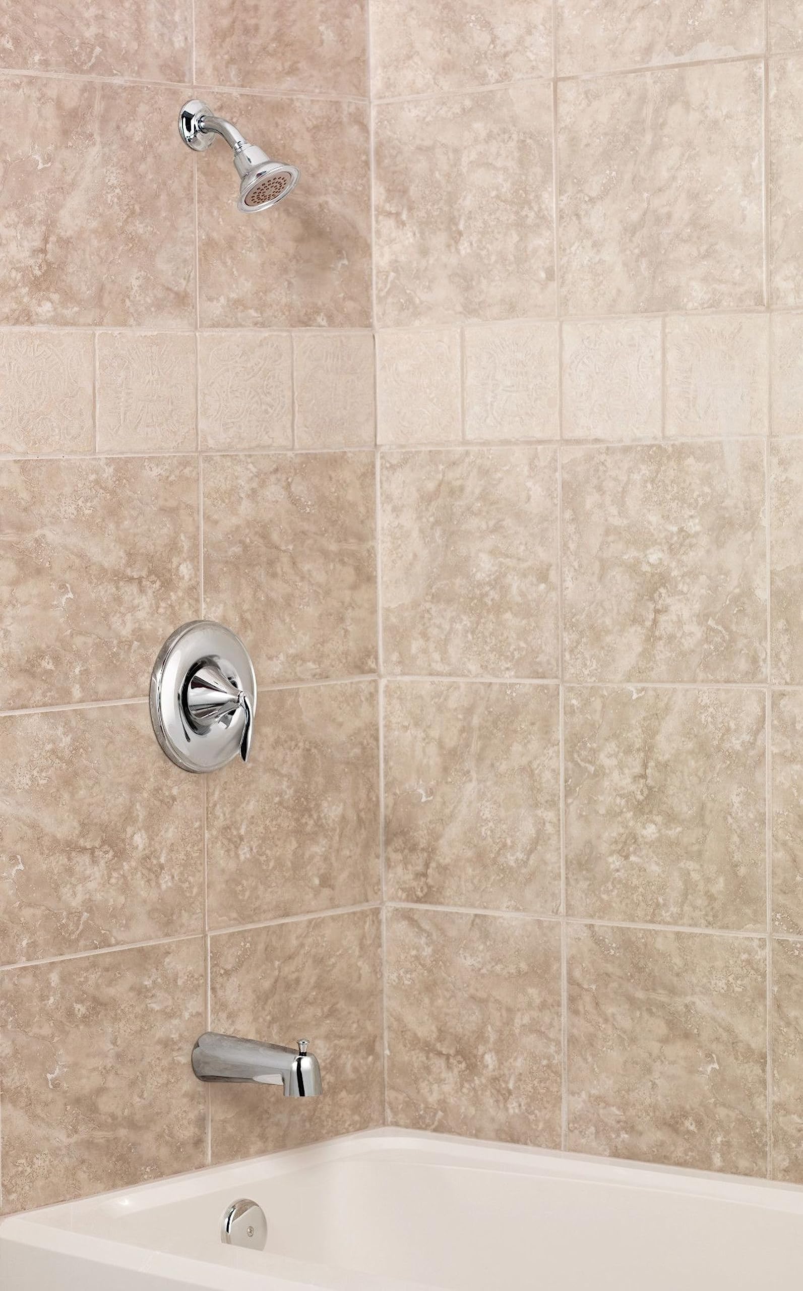 Chrome shower trim kit with round escutcheon plate, lever handle, showerhead, and tub spout mounted on tile wall.