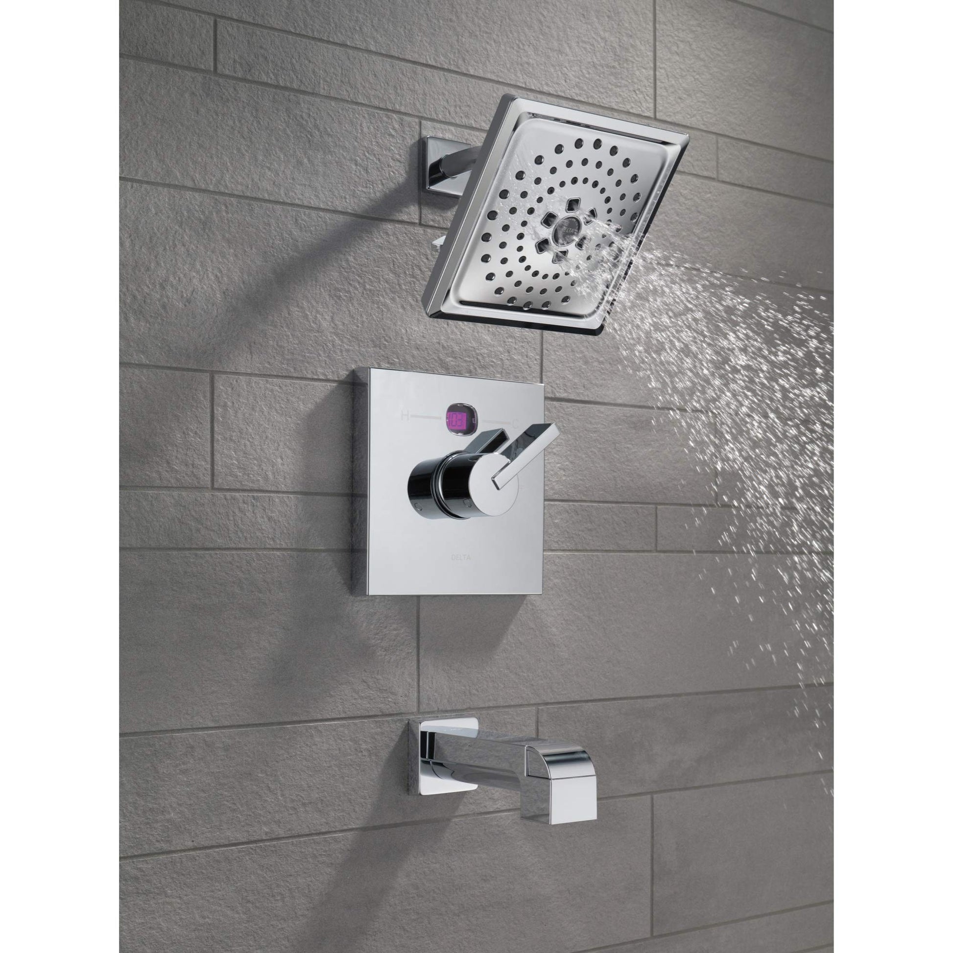 Matte black and chrome tub spout with pull-up diverter mounted on tile wall with matching showerhead above.