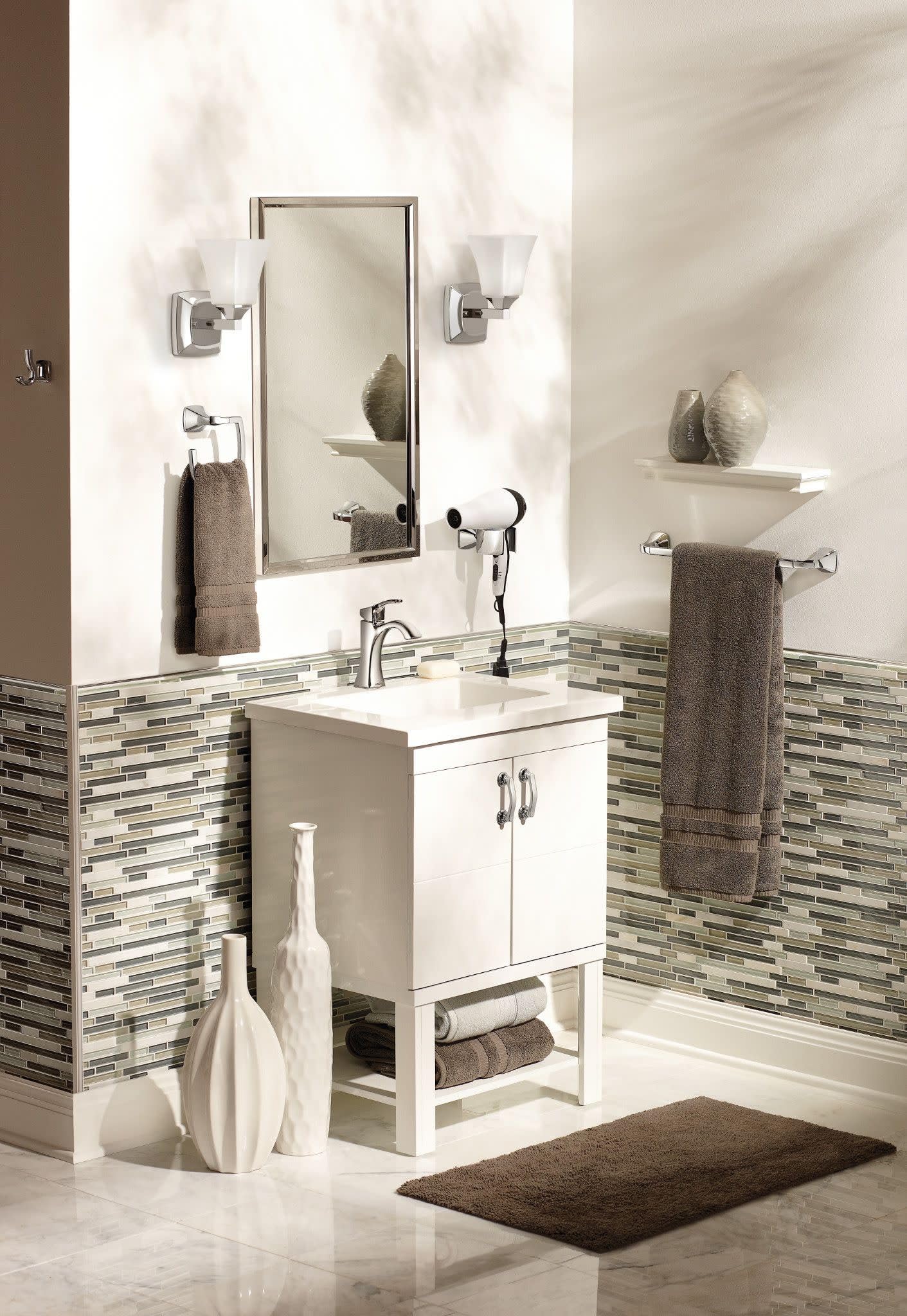 Chrome single-handle bathroom sink faucet with tall curved spout mounted on white sink vanity.
