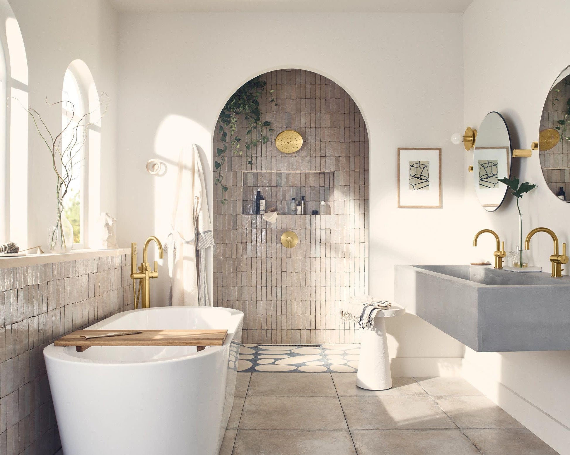 Brushed gold shower trim with single handle mounted on tiled shower wall in modern bathroom.