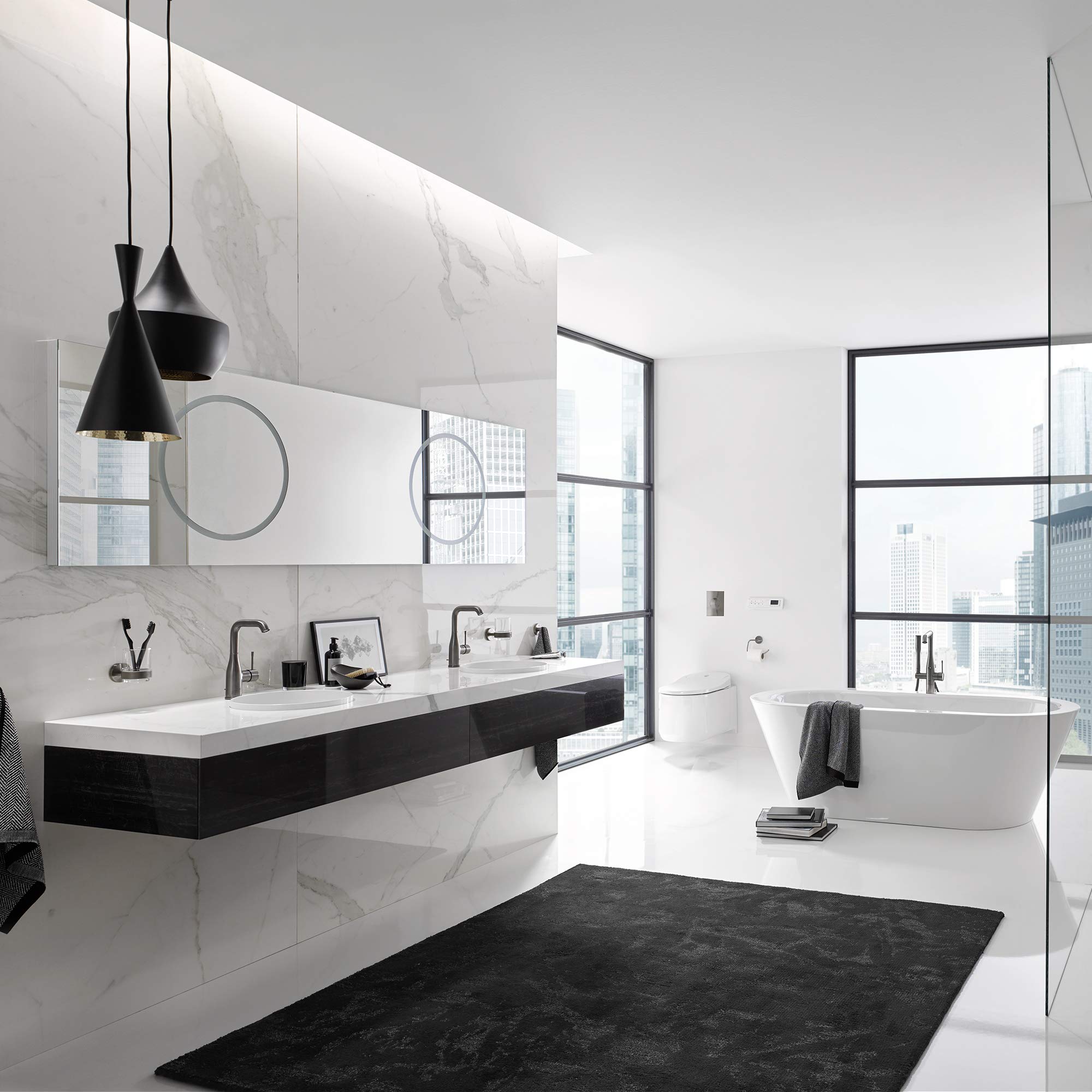 Dark graphite single-handle bathroom faucet with tall curved spout mounted on white countertop sink.