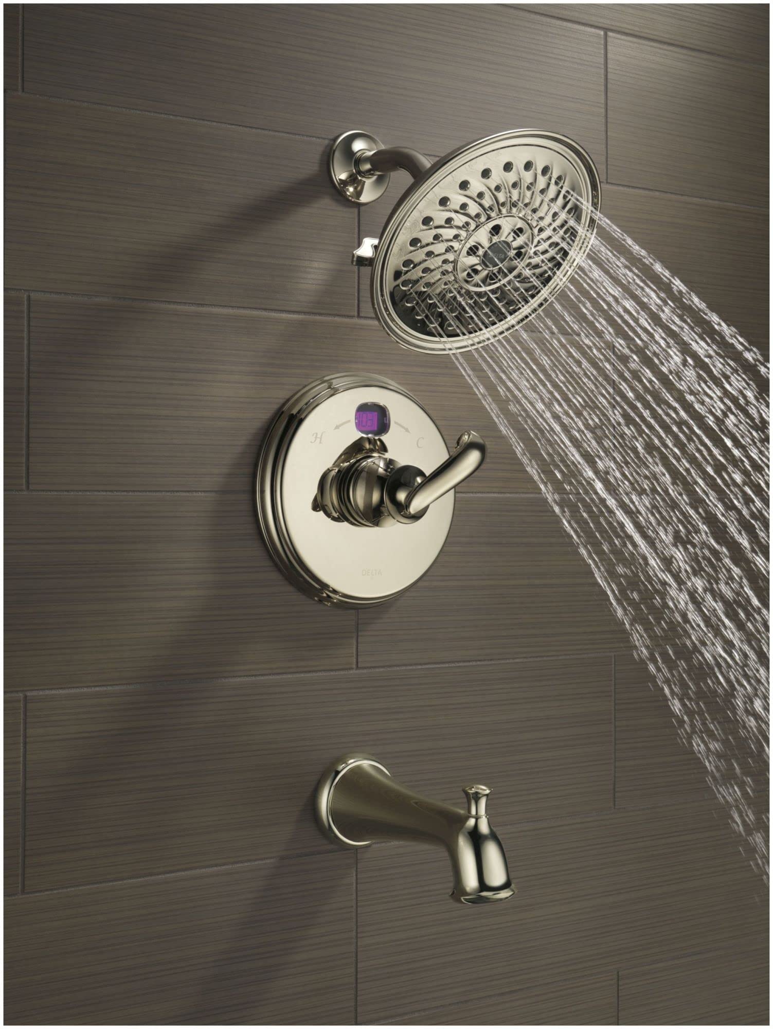 Black stainless steel shower system installed on tile wall with overhead rainfall showerhead, valve trim, and tub spout.