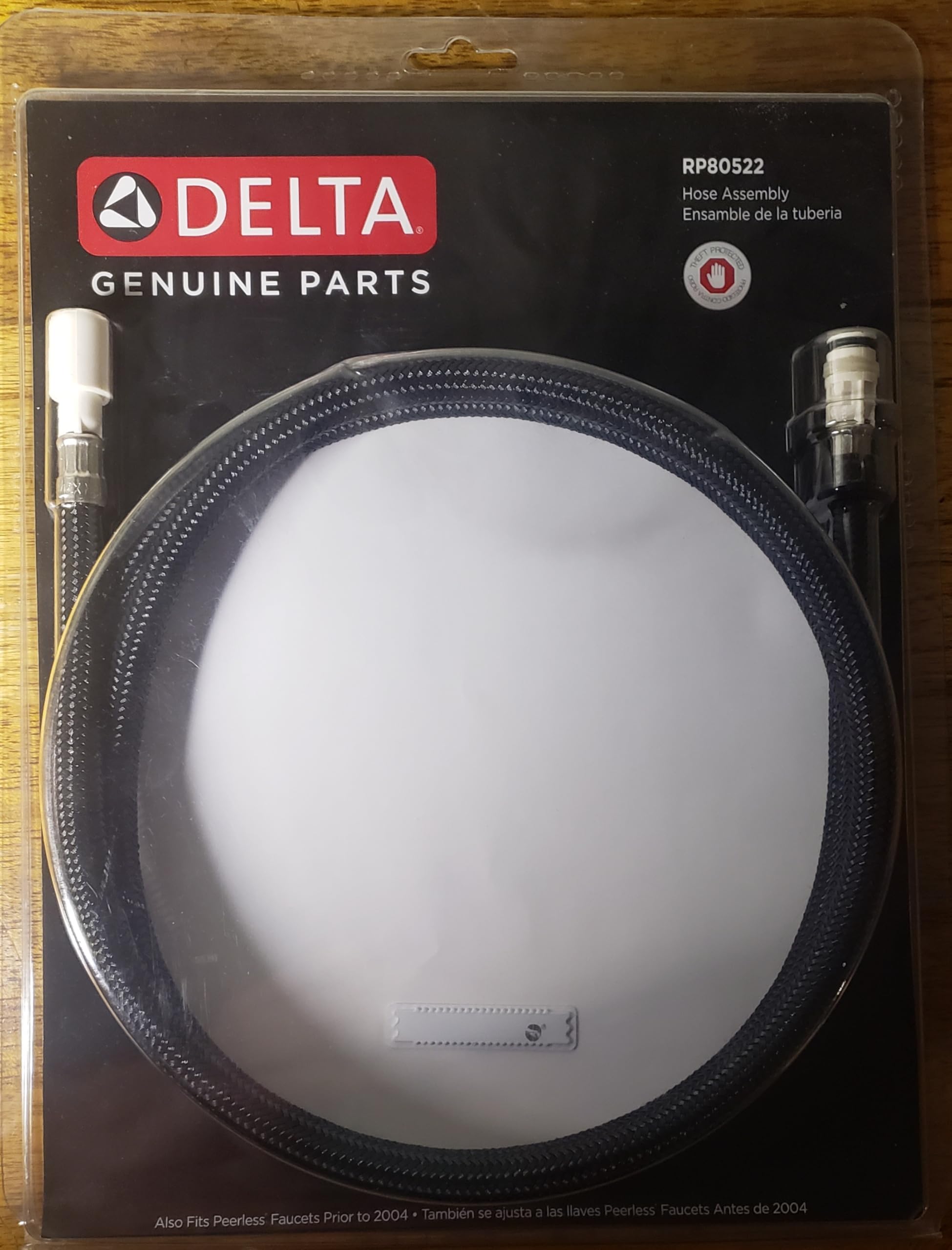 Delta RP80522 hose assembly with braided tubing and threaded connectors on packaging.