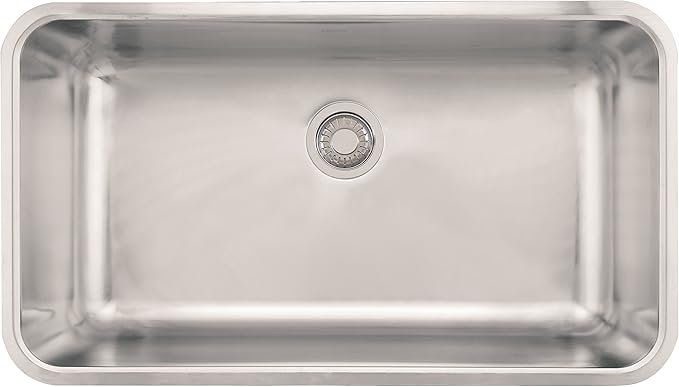 Polished stainless steel rectangular single bowl sink with rounded corners and center drain.