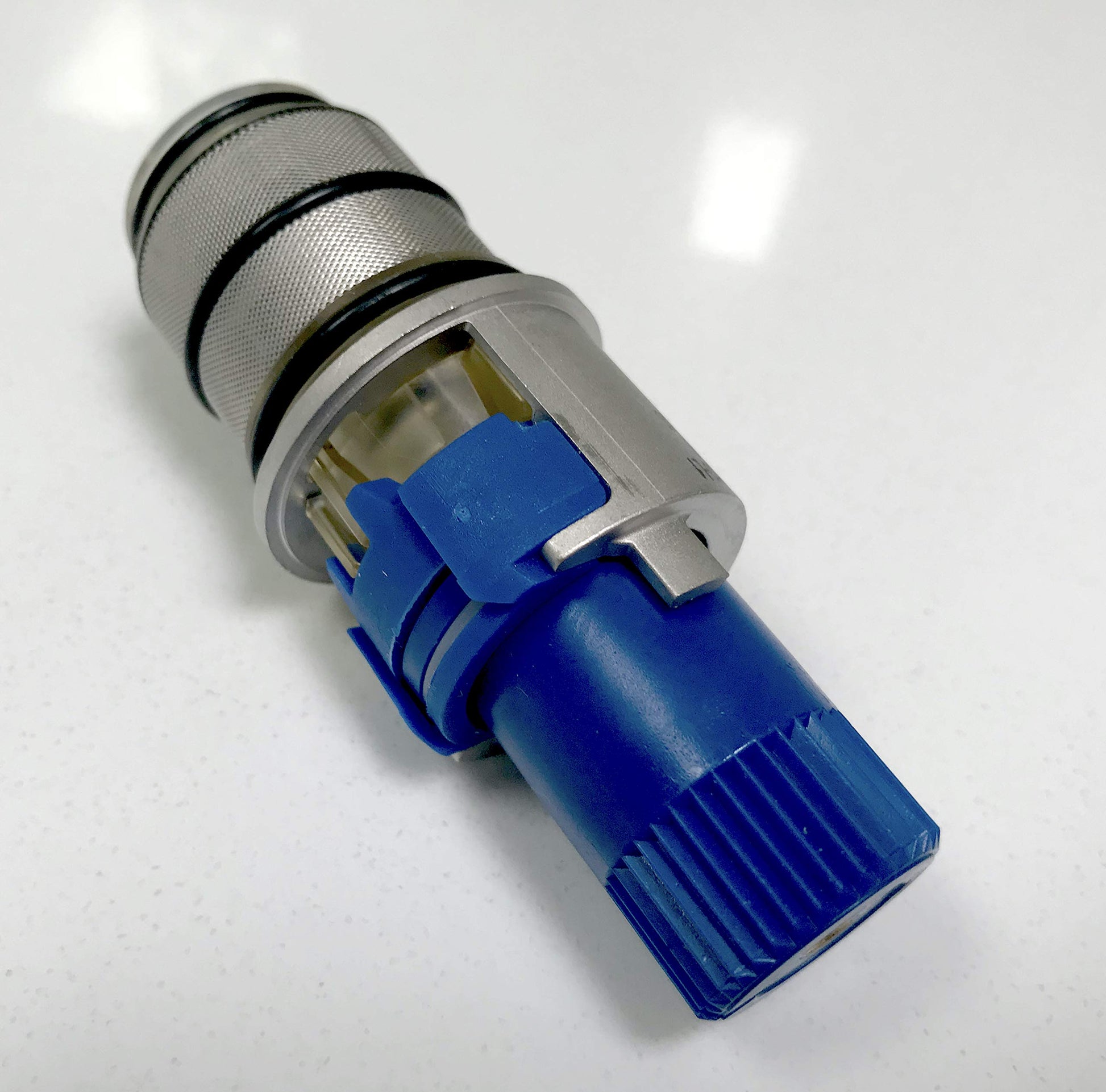 Chrome thermostatic cartridge with blue lower stem, metal mesh grip section, and internal brass components visible.