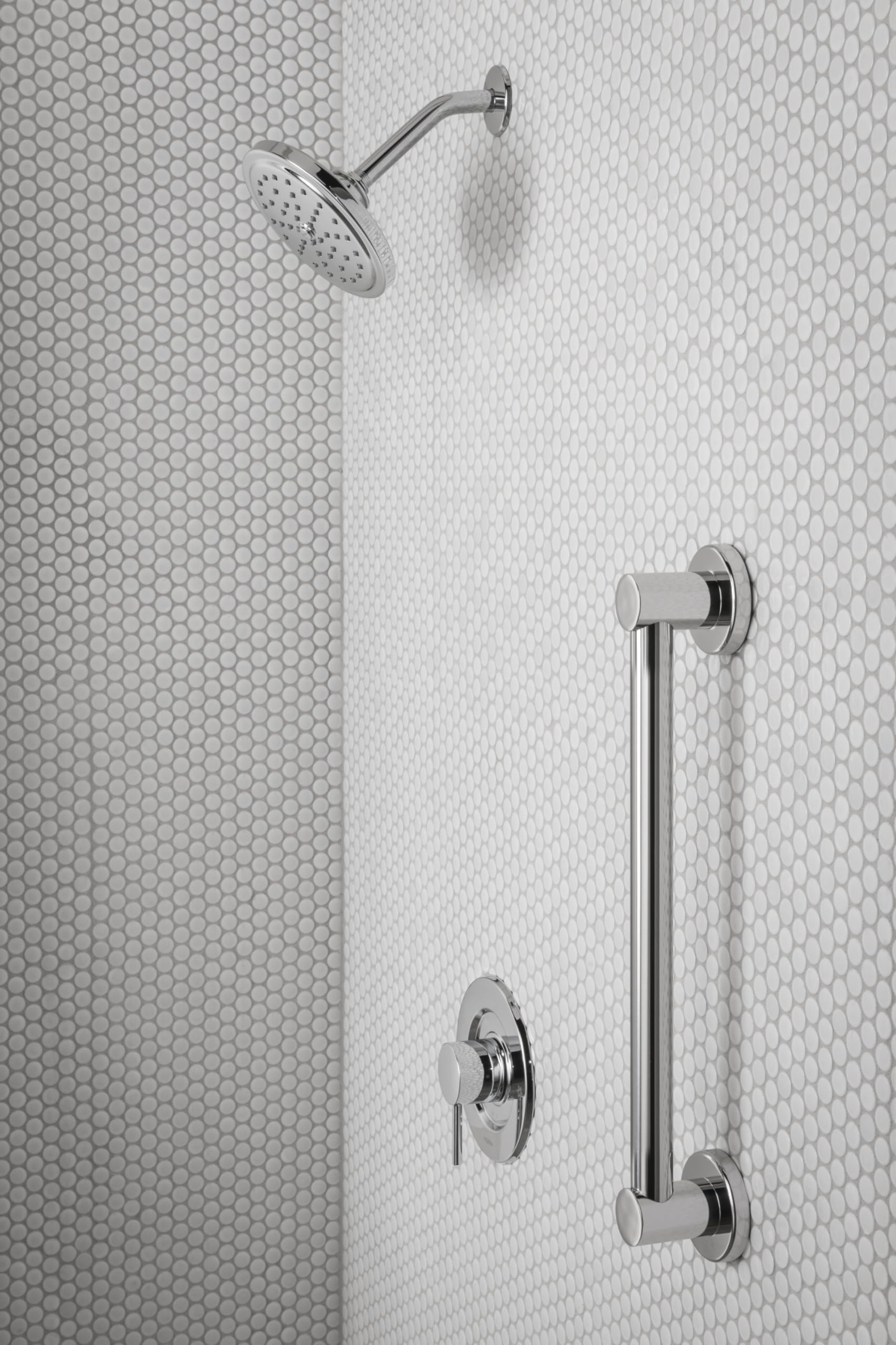 Chrome shower trim kit with single handle control, curved shower arm, rainfall showerhead, and vertical grab bar mounted on t