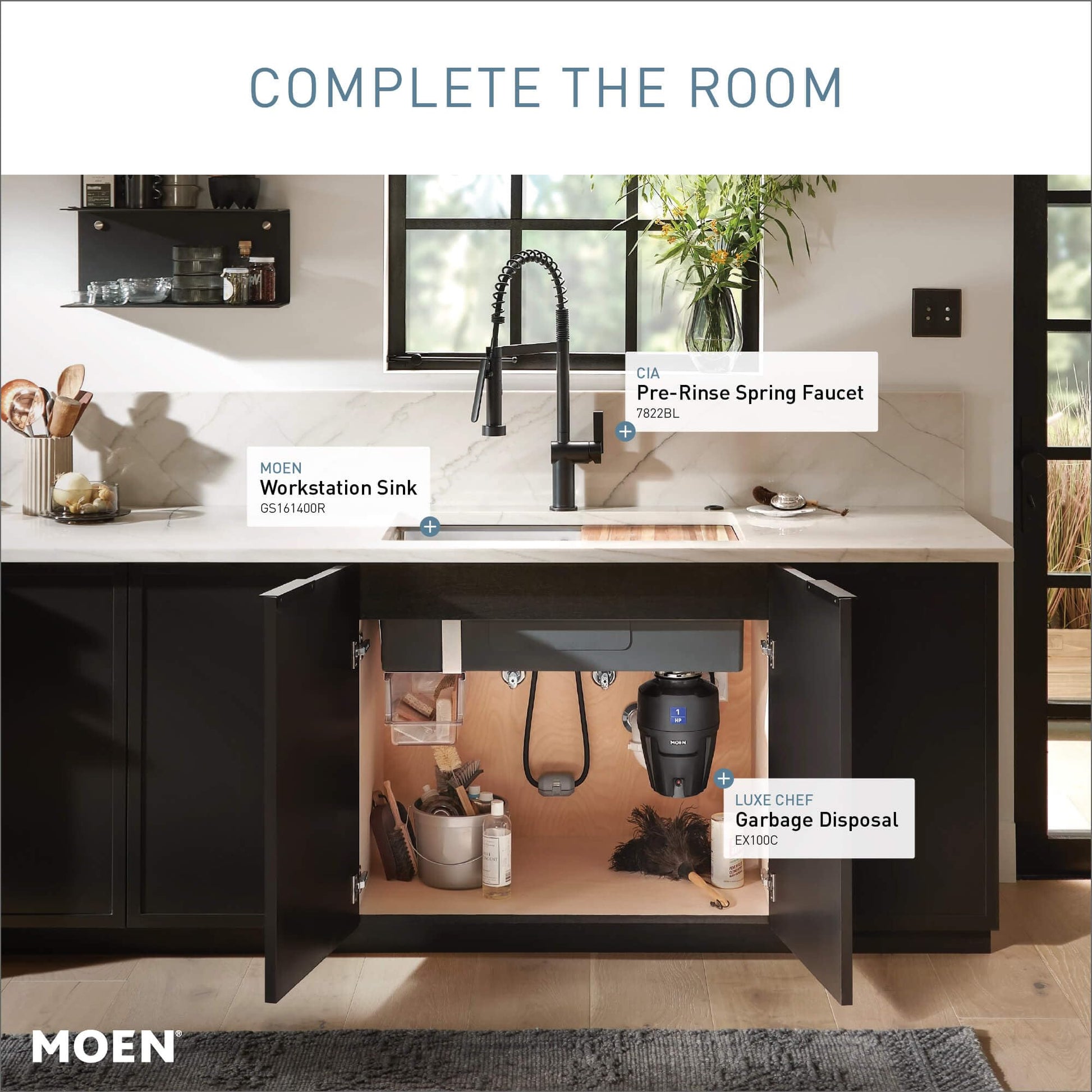 Matte black pre-rinse spring kitchen faucet with curved spout and coiled hose attached to sink.