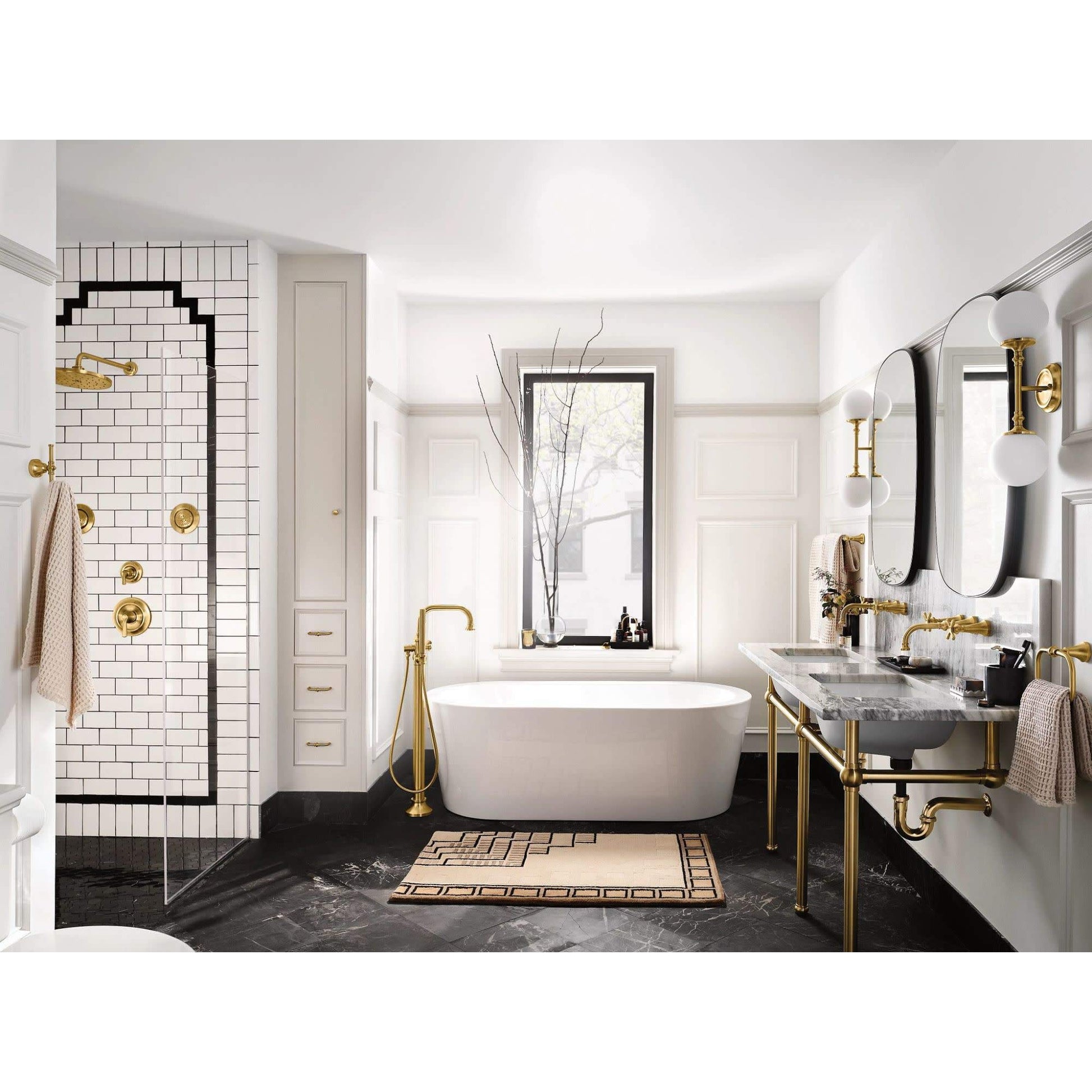 Matte black freestanding tub filler with single handle and attached handshower, displayed in bathroom setting.