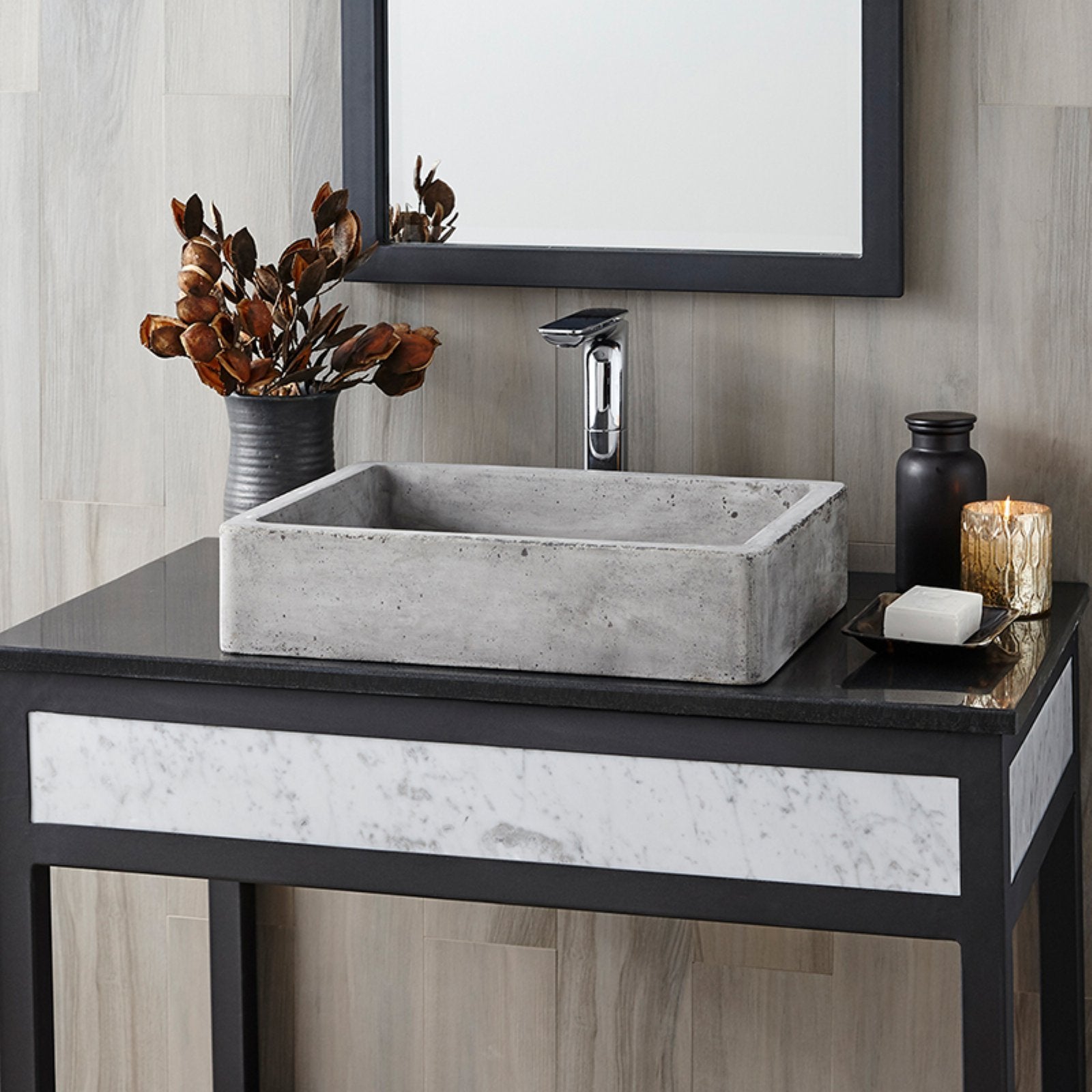 Slate-colored concrete rectangular bathroom sink with textured surface on black vanity countertop.