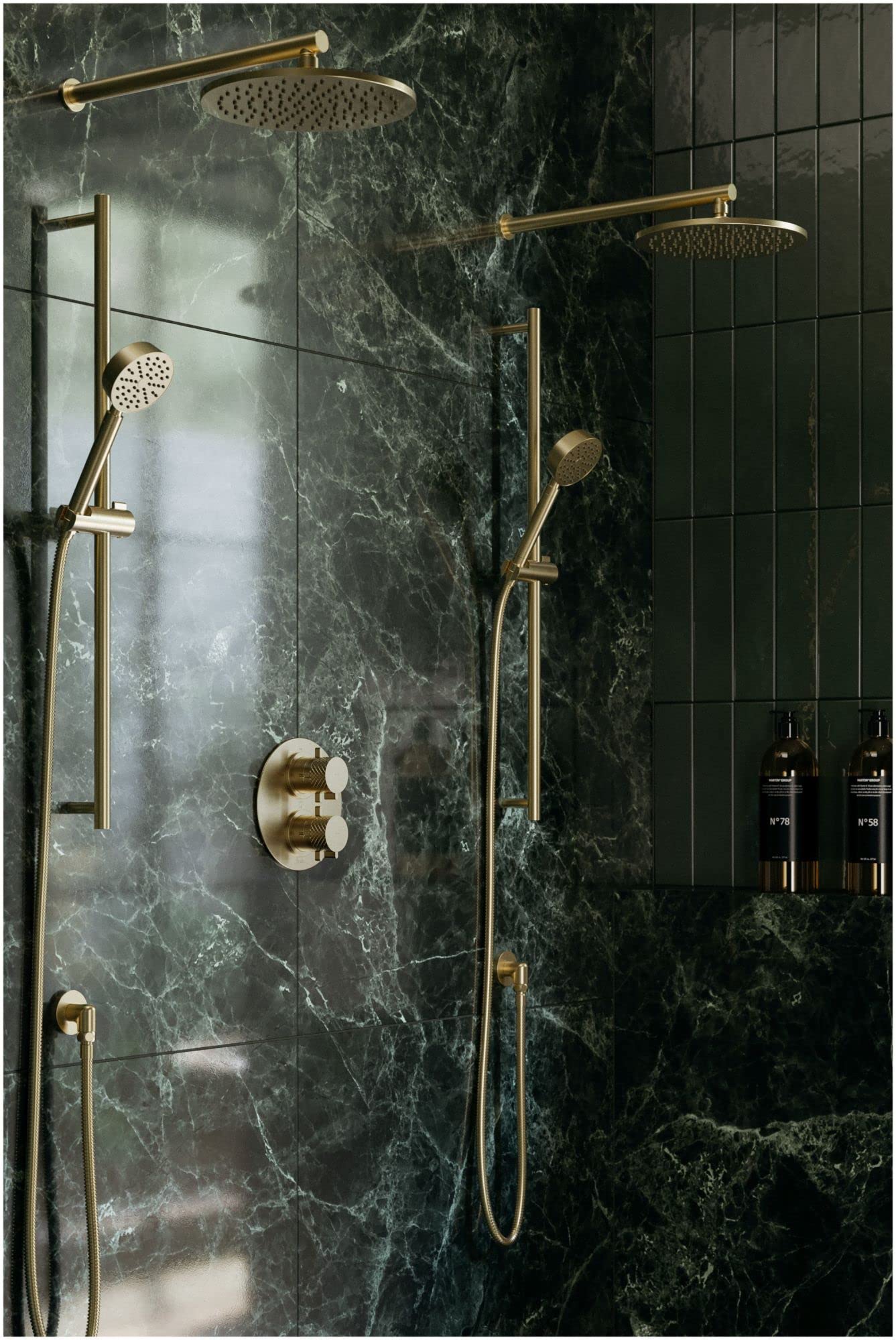 Antique gold wall-mount shower arm with perforated showerhead shown installed in bathroom shower setup against dark marble ti