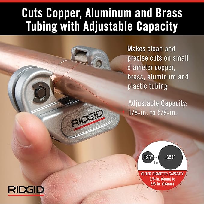 RIDGID tubing cutter with adjustable capacity held in hand, cutting copper tubing.