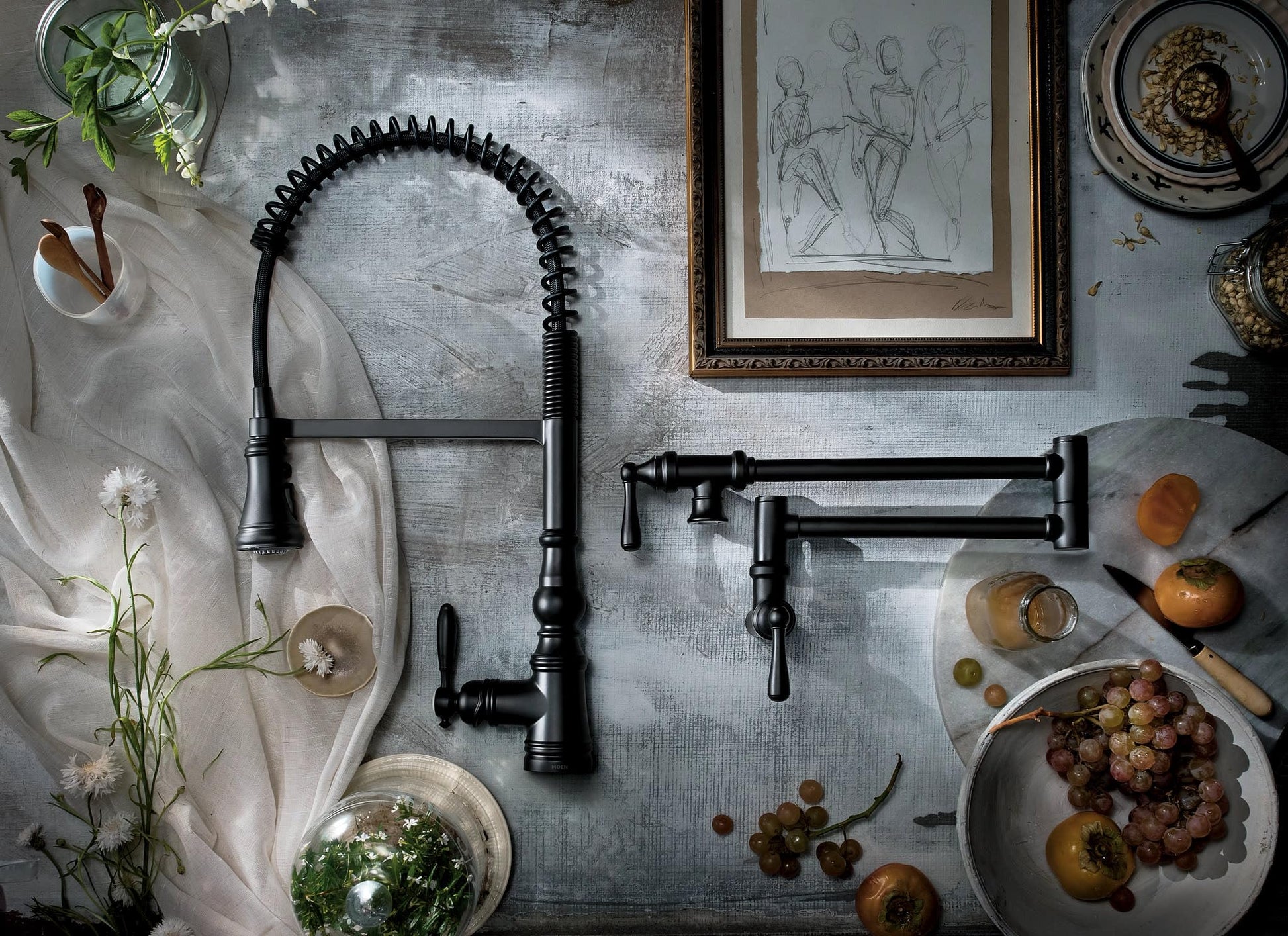 Matte black wall-mount pot filler faucet with coiled spring hose and swing arm in traditional style.