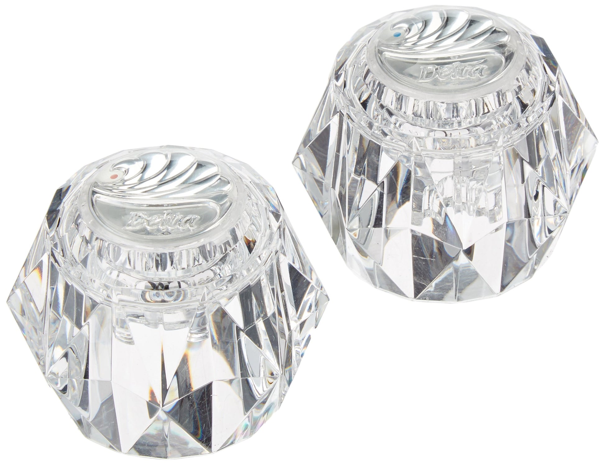Two clear acrylic knob handles with faceted geometric design and Delta branding on top.