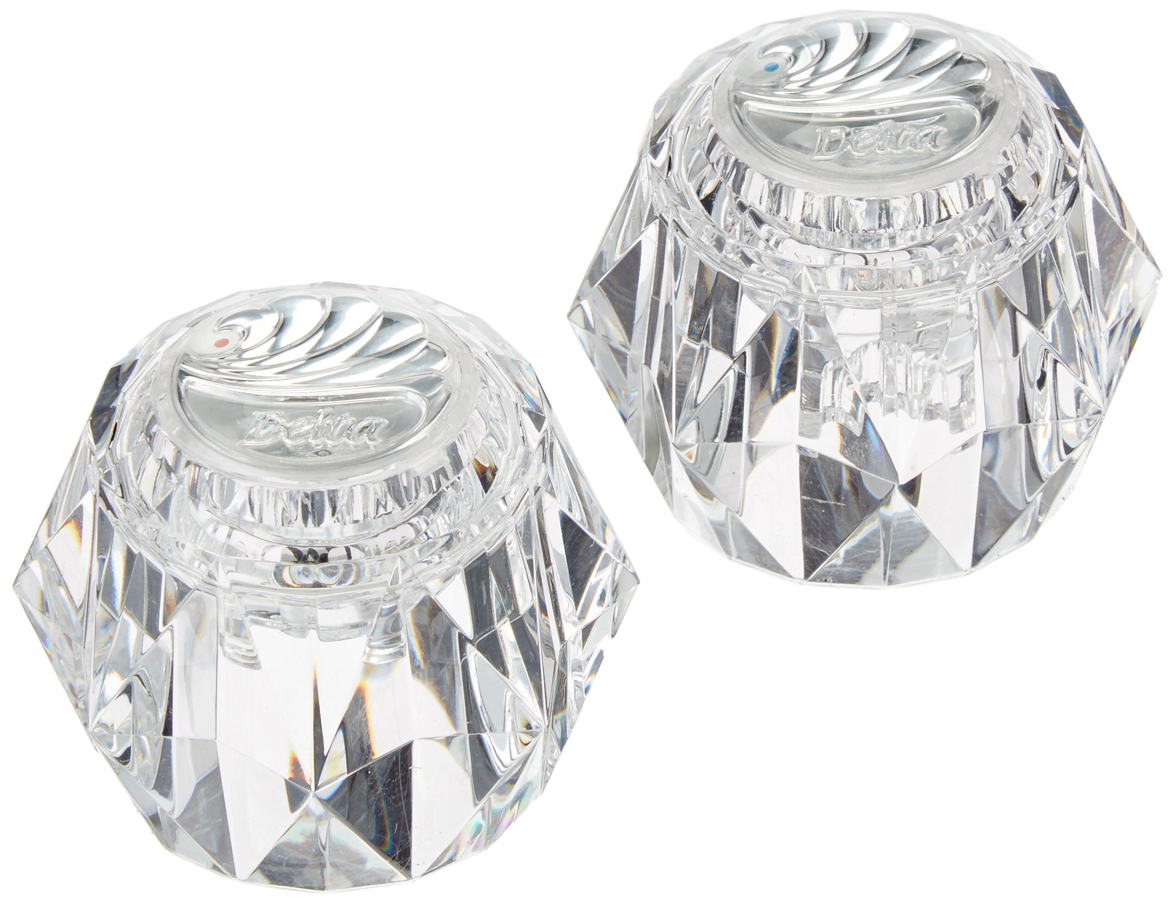 Two clear acrylic knob handles with faceted geometric design and Delta branding on top.