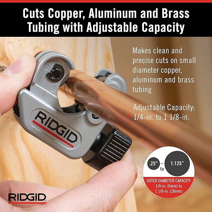 RIDGID close quarters tubing cutter with adjustable capacity held in hand, positioned on copper tubing.