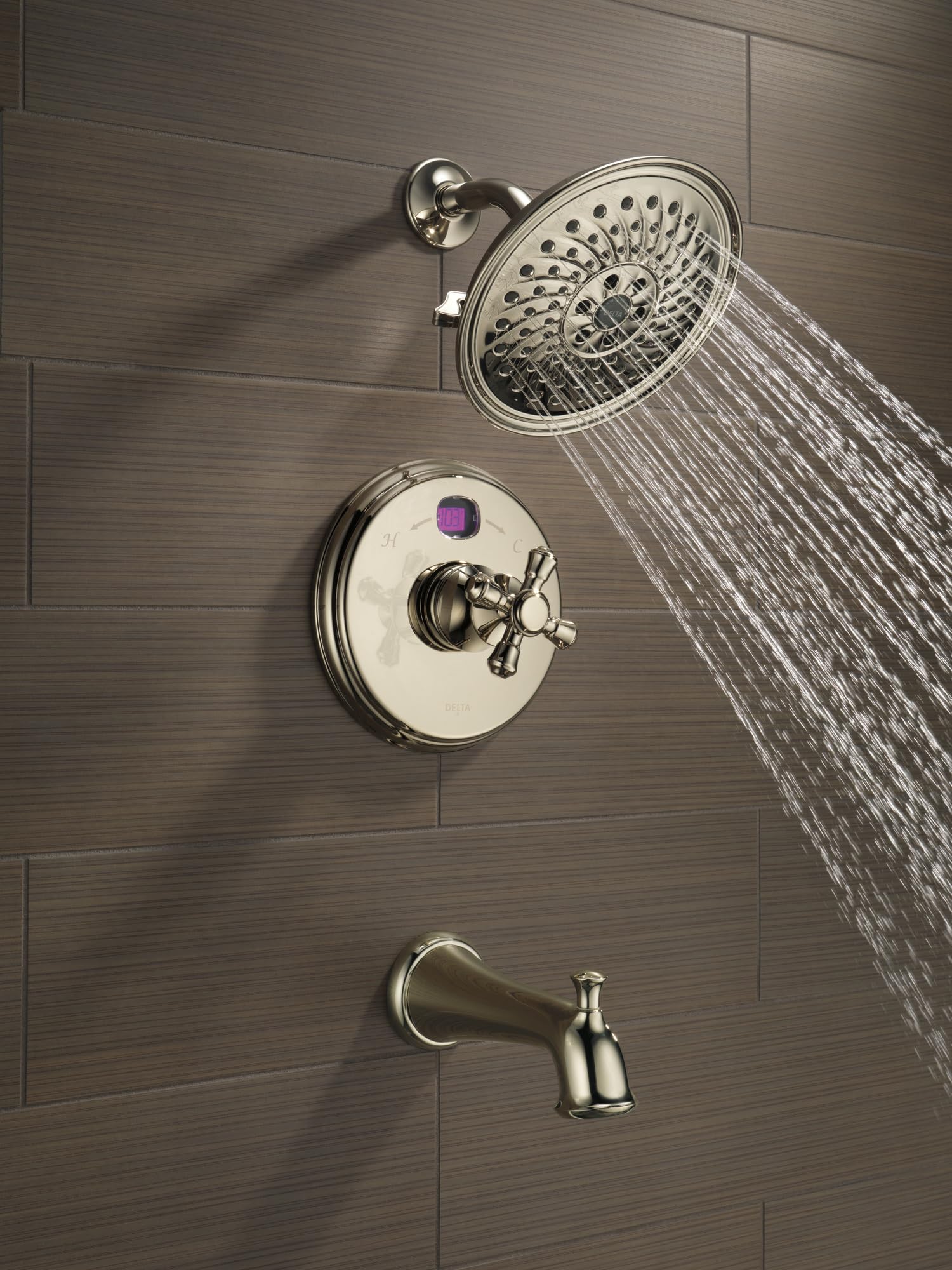 Polished nickel shower flange with circular trim ring mounted on tile wall with shower head and control valve.