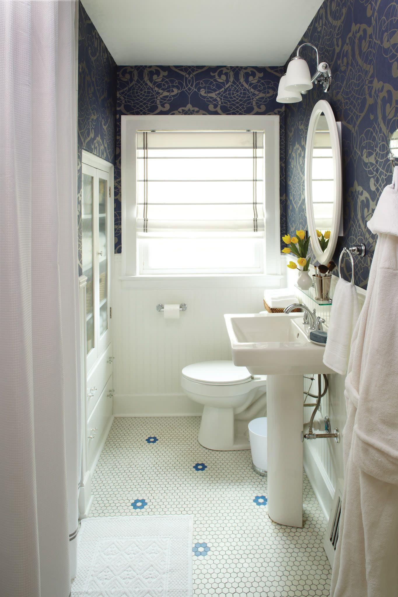 Chrome two-handle widespread bathroom faucet trim with lever handles mounted above white pedestal sink.