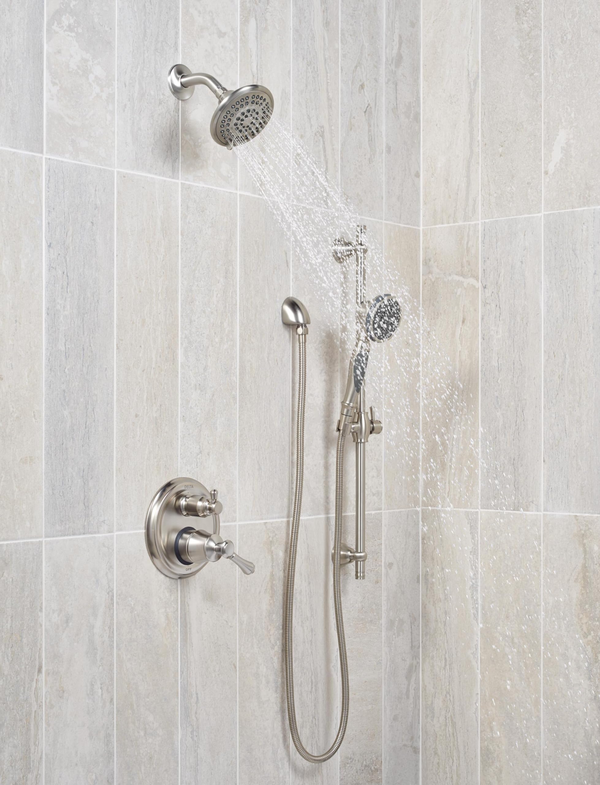 Stainless steel raincan shower head with hand shower and flexible hose mounted on tile wall with control valve.