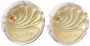 Two polished brass circular buttons with clear bezels, red dot indicating hot and blue dot indicating cold, Delta branding vi