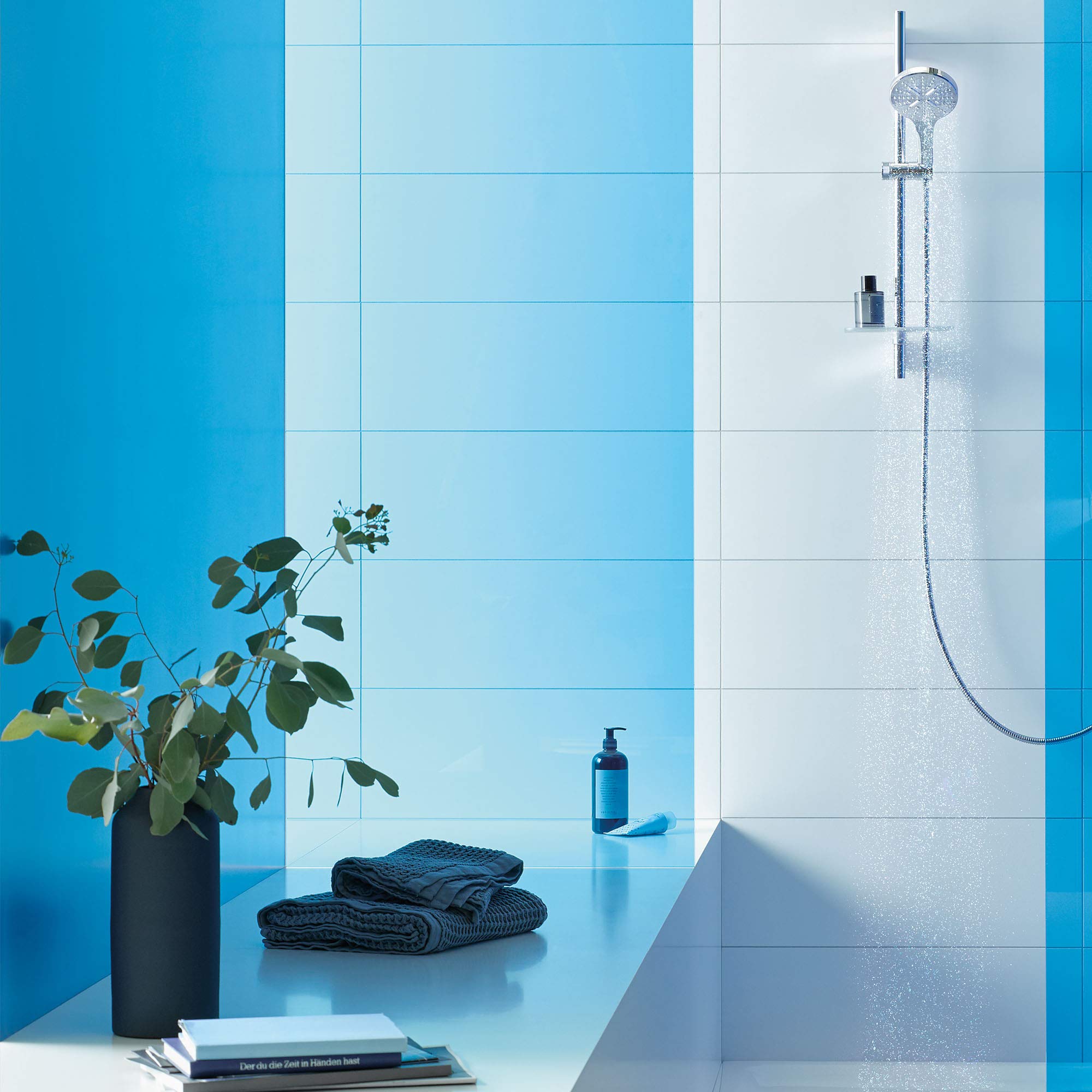 Chrome slide bar shower kit with round showerhead and handheld spray mounted on white tile wall.