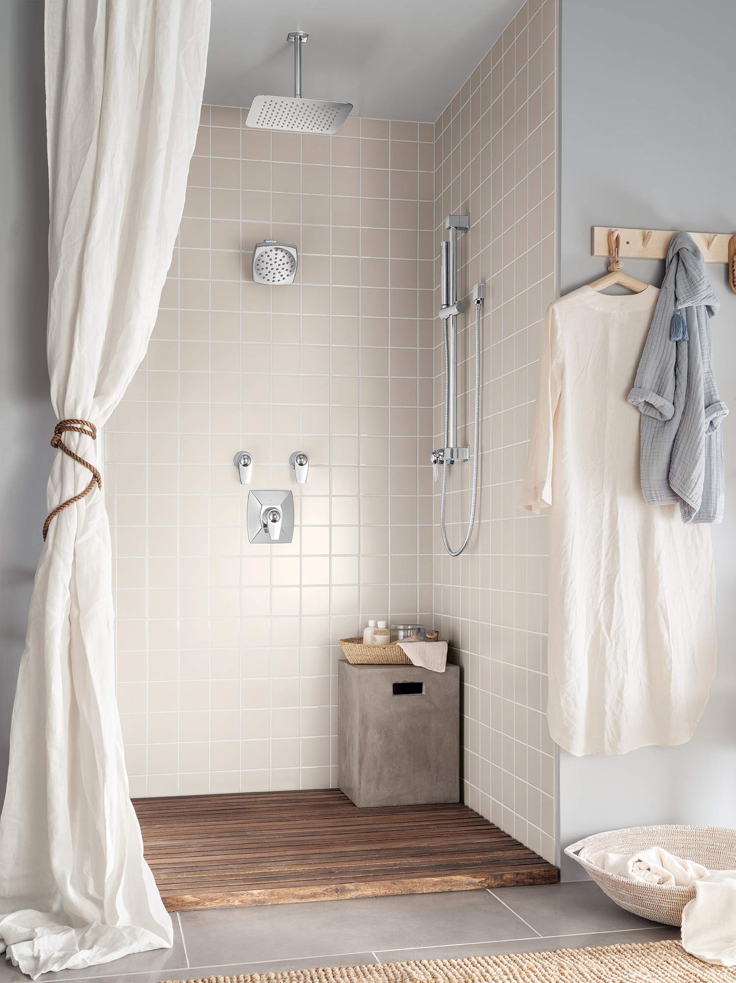 Chrome 6" square rainshower showerhead mounted on ceiling with chrome handheld shower wand and valve controls in tiled shower