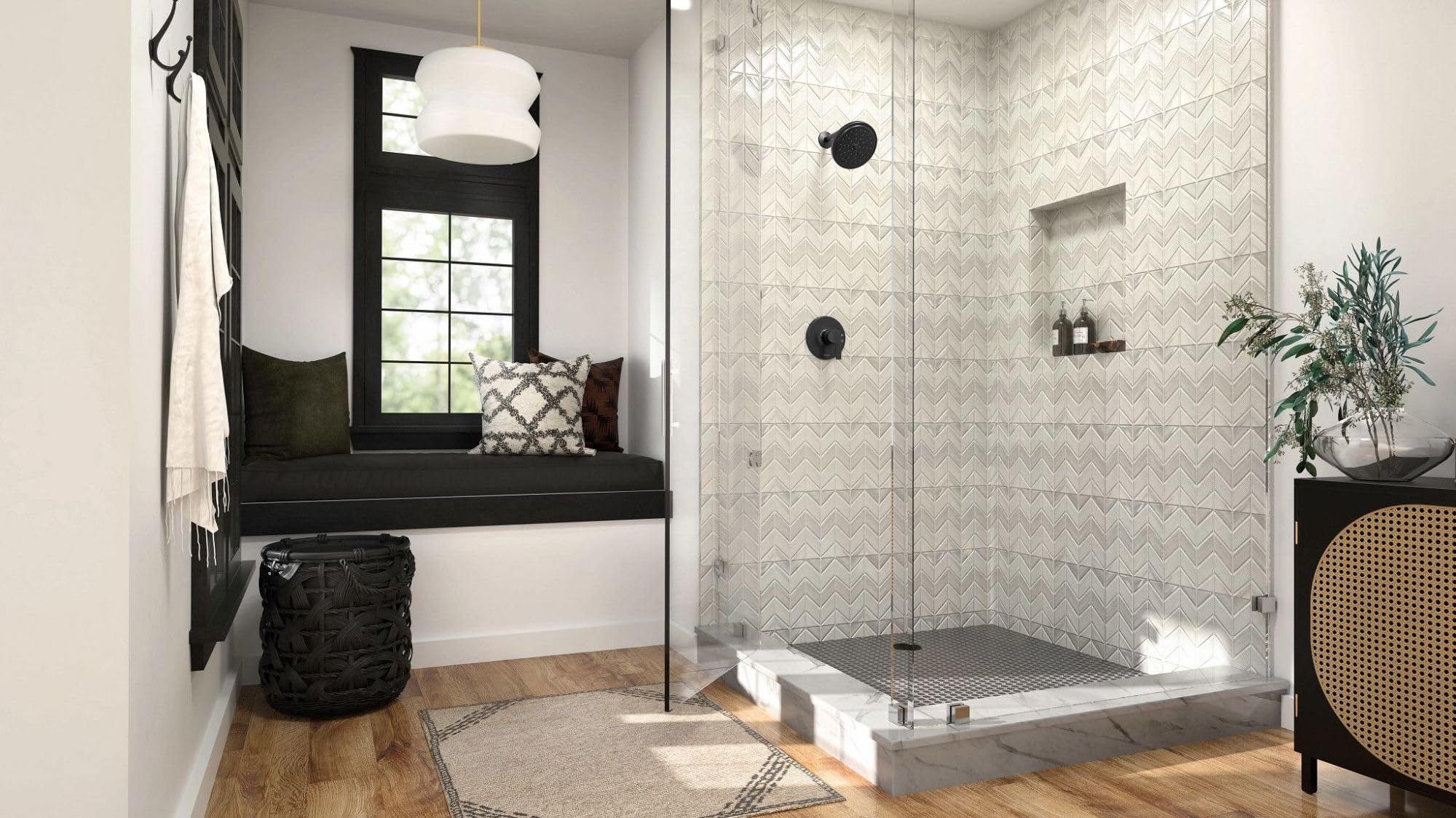 Matte black single-handle shower trim with round escutcheon mounted on herringbone tile shower wall.