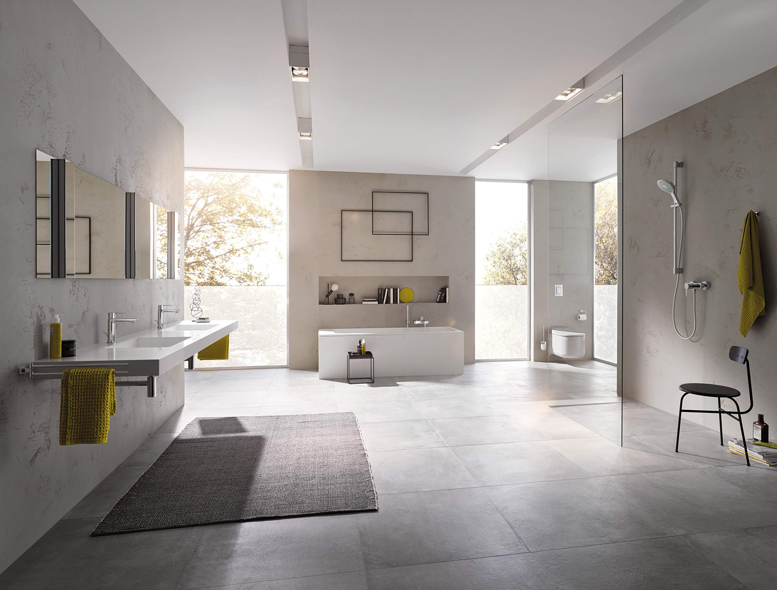 Chrome single-handle bathroom faucet with tall spout and lever handle mounted on white sink counter.