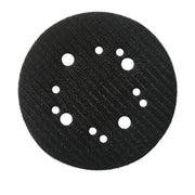 Black circular sanding pad with textured surface and white mounting holes arranged in pattern.