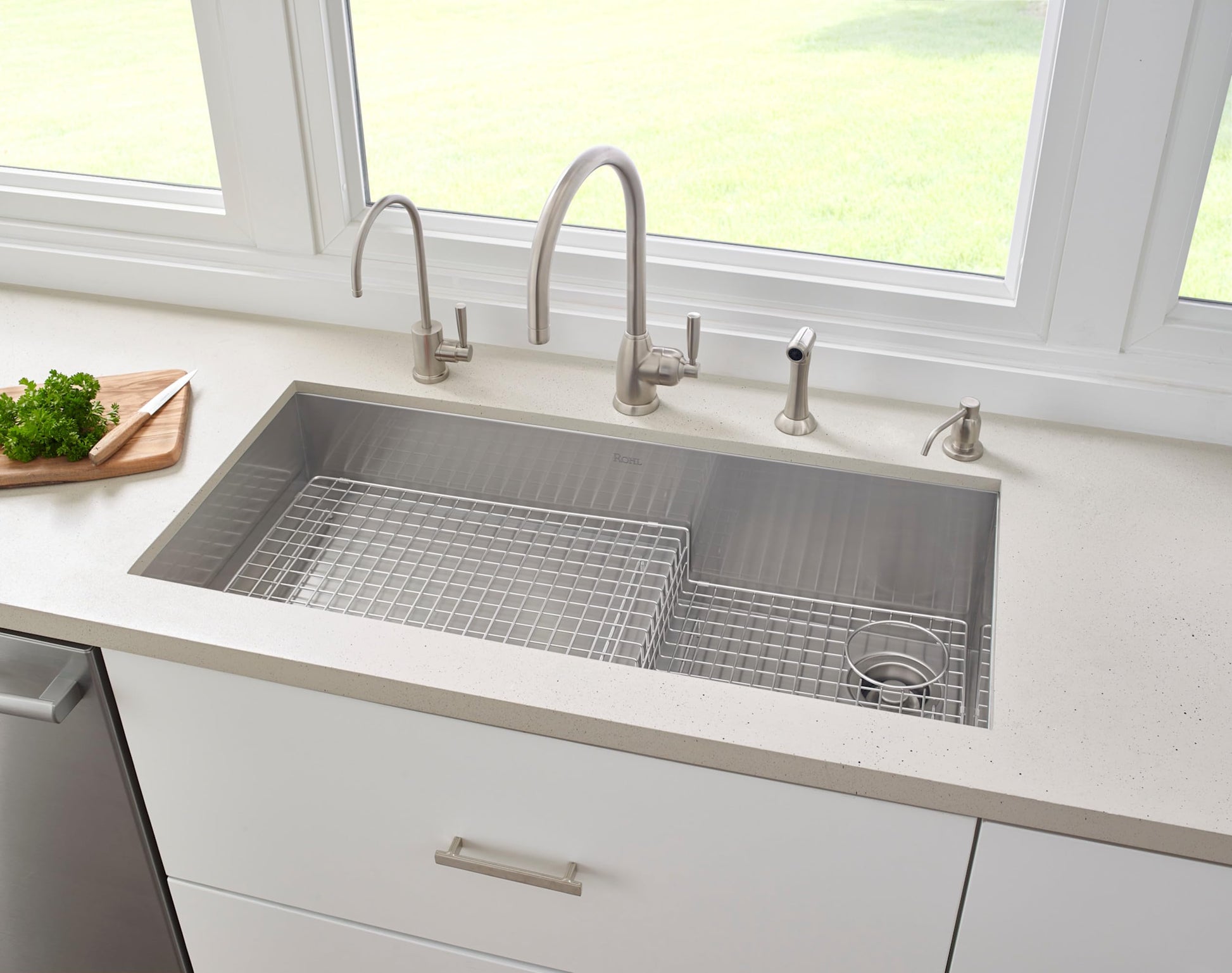 Black stainless steel garbage disposal flange with circular rim and mounting hardware.