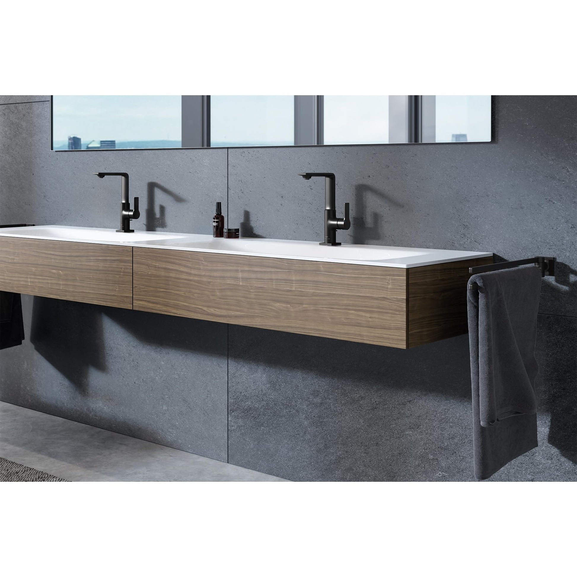 Chrome single-handle bathroom faucet with L-shaped spout installed on floating vanity with white sink and gray tile backsplas