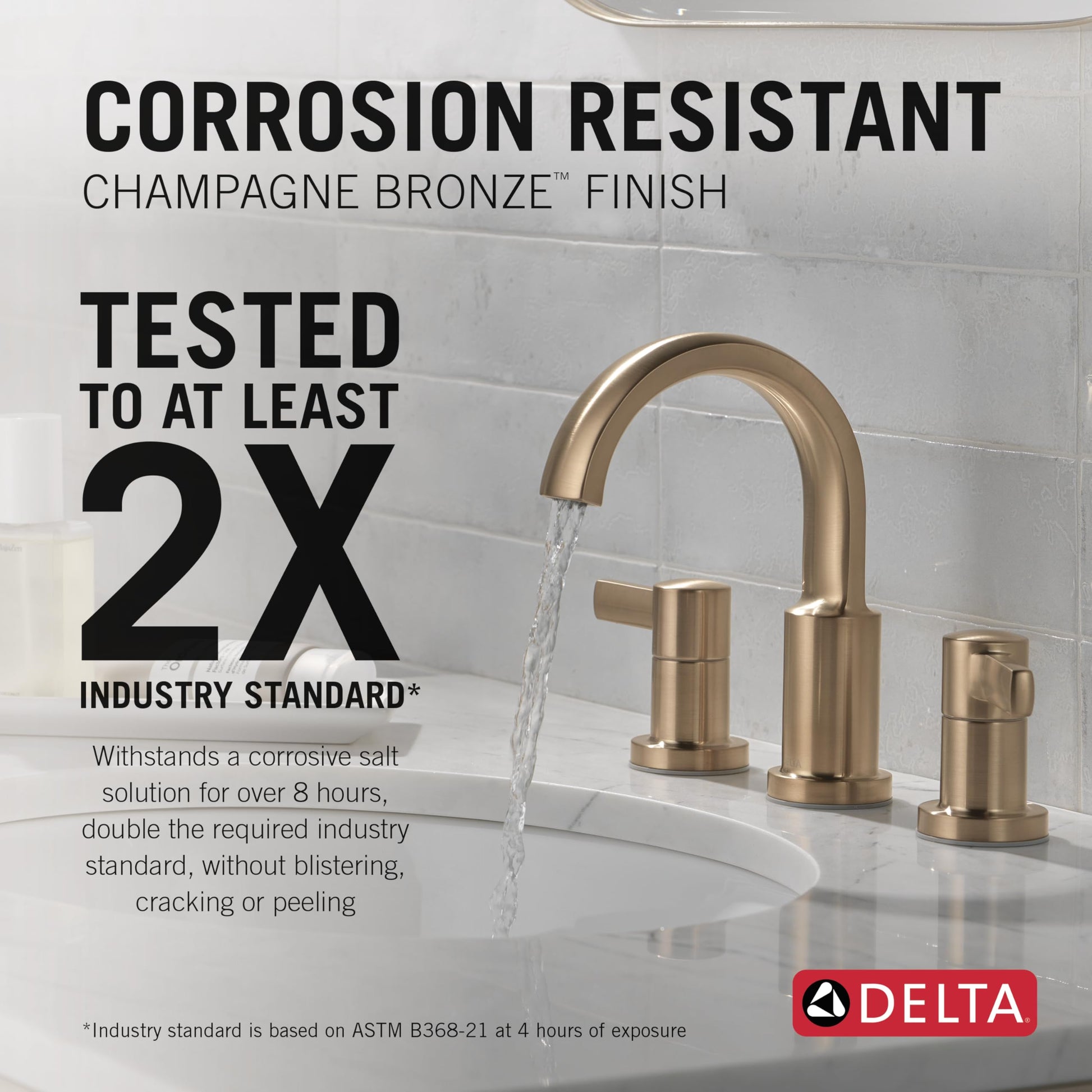 Champagne bronze two-handle widespread bathroom faucet with curved spout and cylindrical handles on white sink.