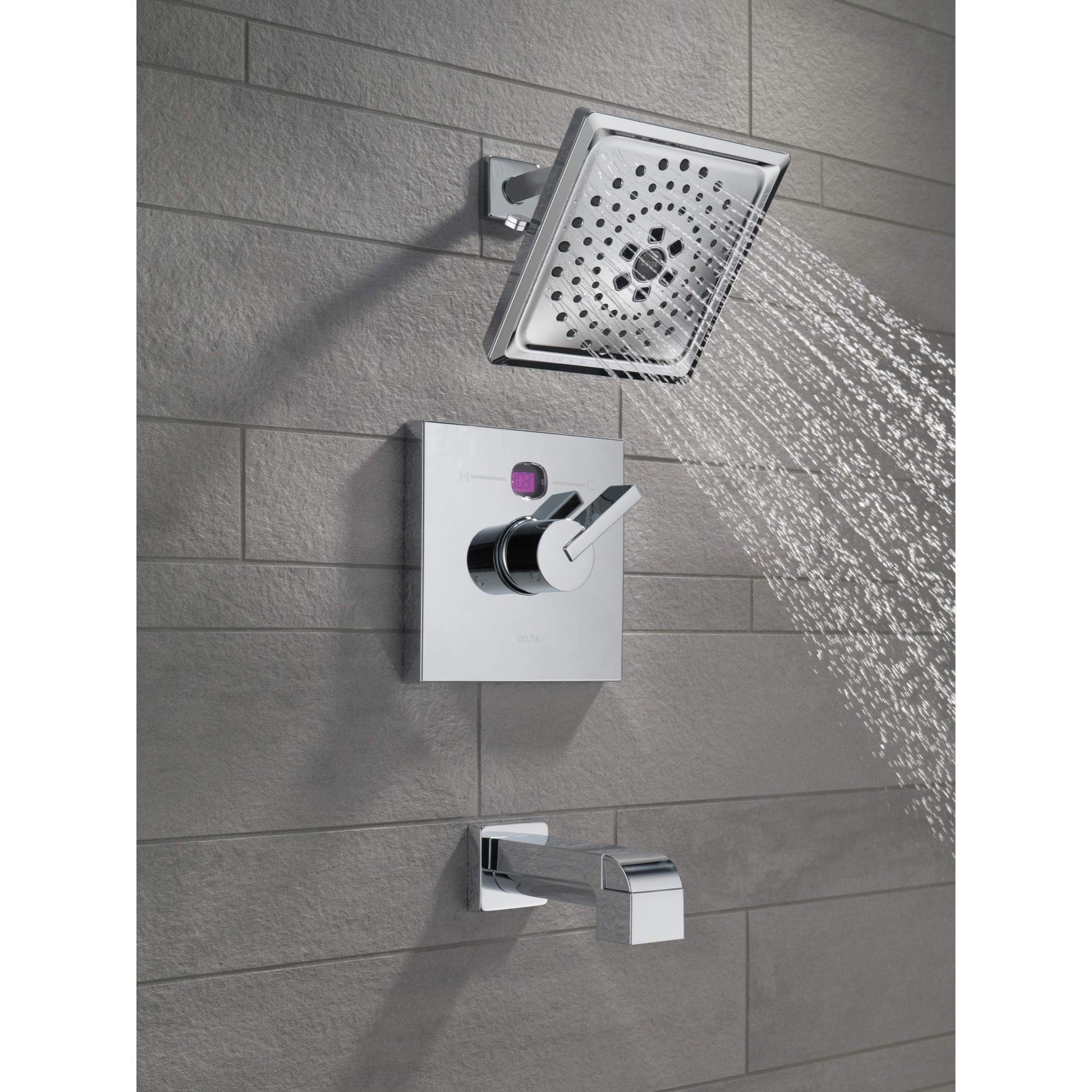 Matte black tub spout with pull-up diverter mounted on tile wall below showerhead.