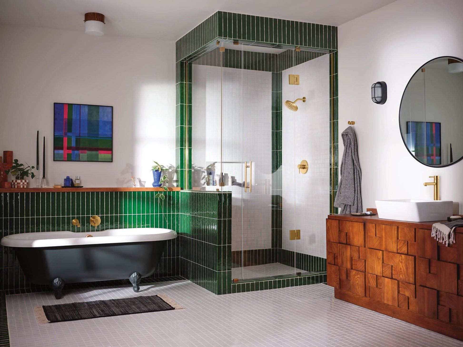 Brushed gold lever handle shower trim with wide showerhead mounted on white subway tile shower wall.