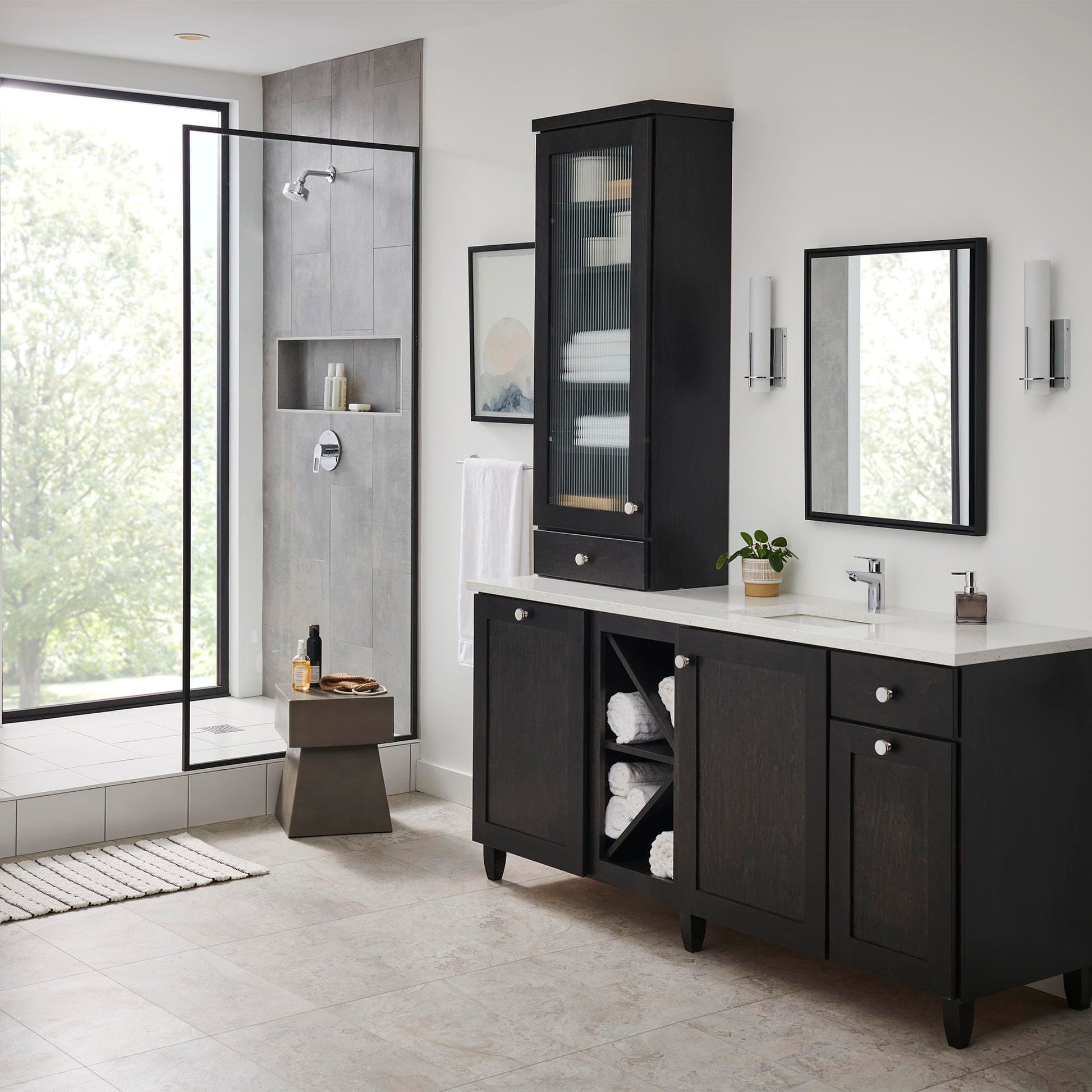 Chrome single-handle bathroom faucet with curved spout mounted on white vanity countertop.