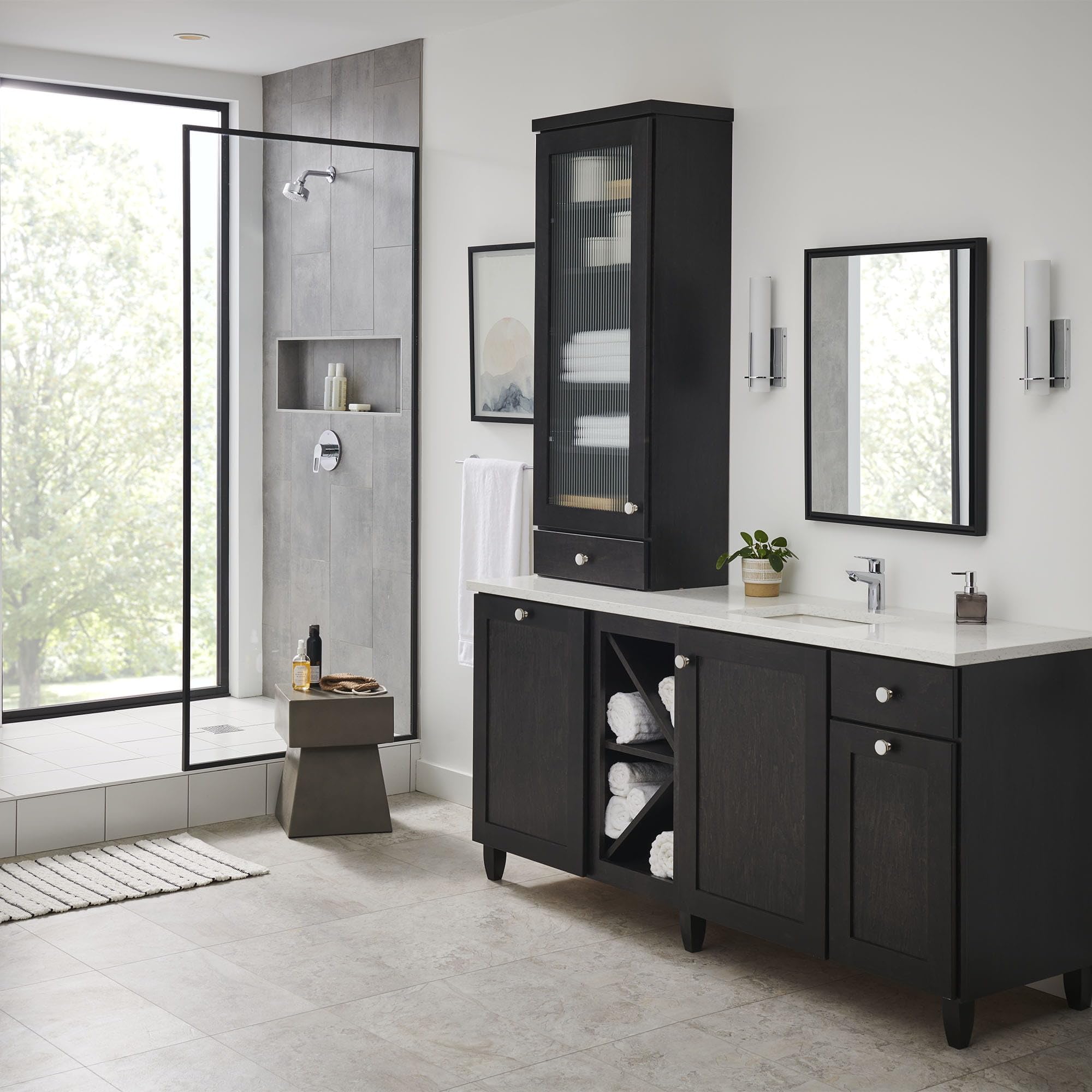 Chrome single-handle bathroom faucet with curved spout mounted on white vanity countertop.