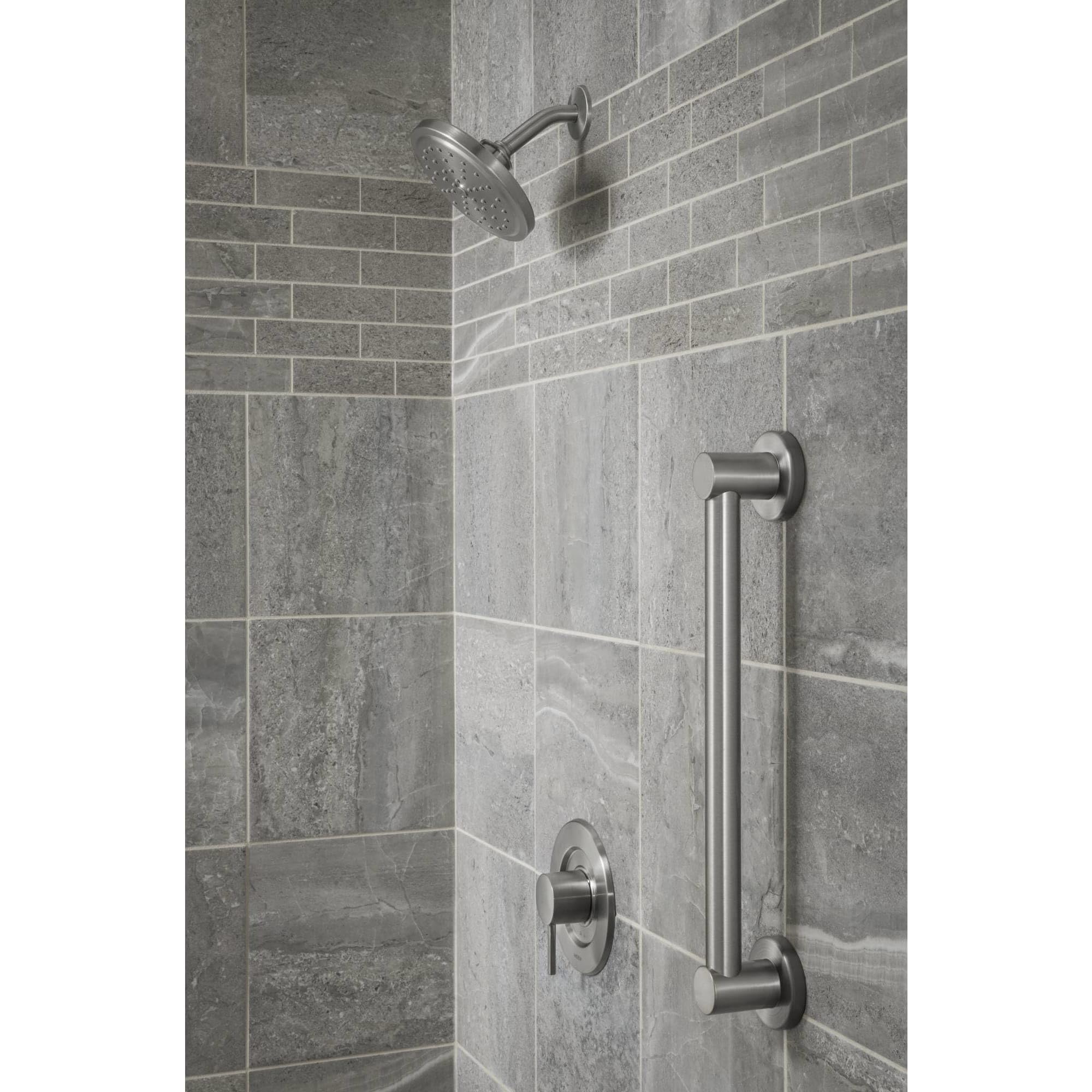 Matte black horizontal grab bar mounted on tiled shower wall next to showerhead and valve controls.