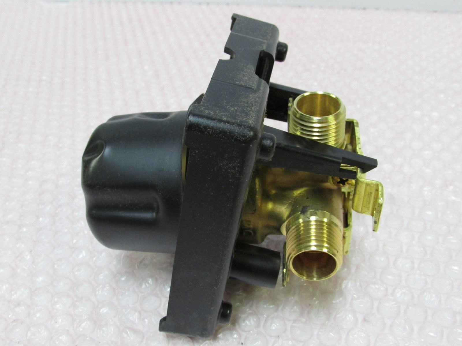 Brizo MultiChoice universal tub/shower rough-in valve with black plastic body and brass threaded ports.