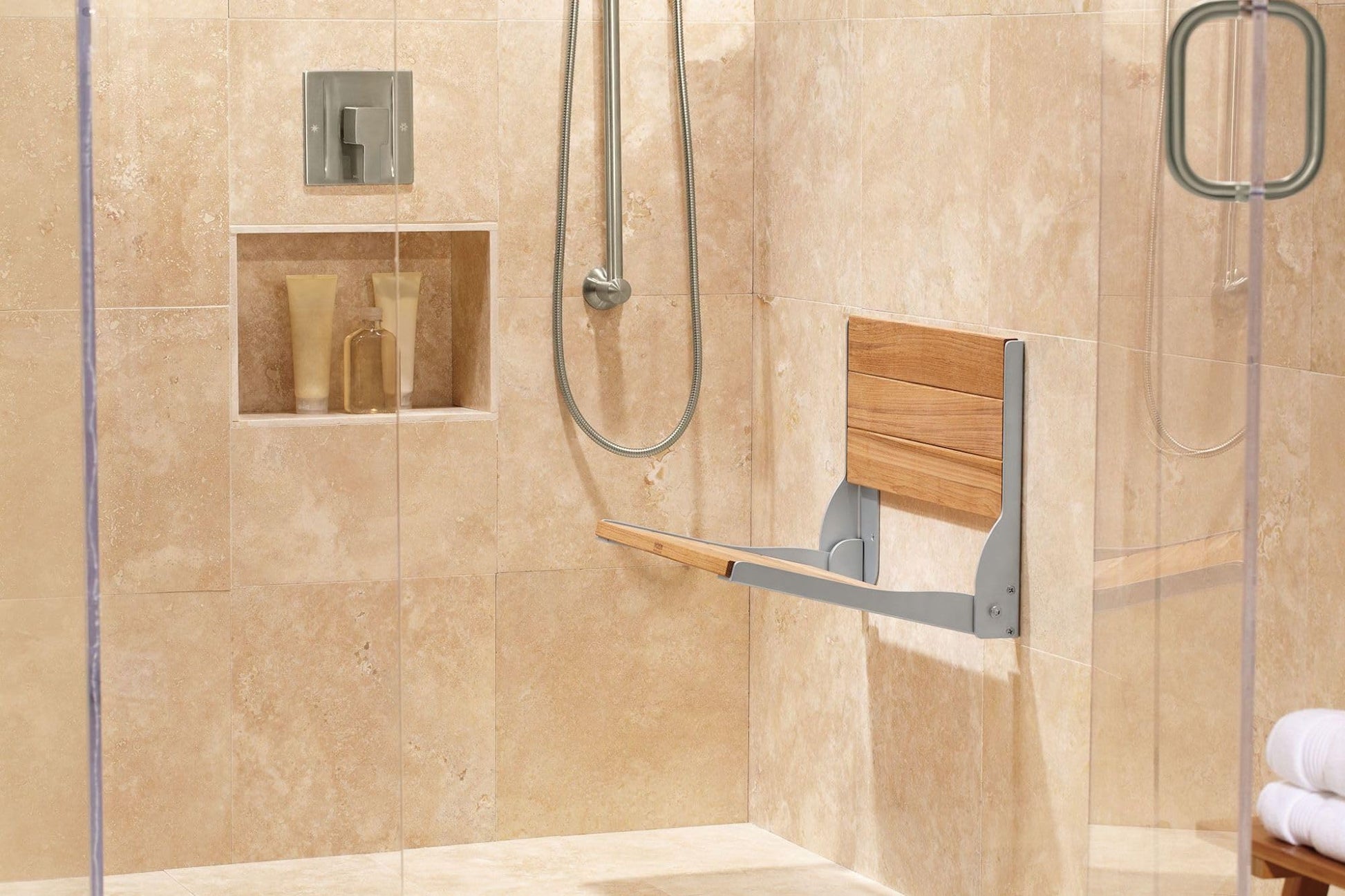 Brushed nickel single-handle shower valve trim with 90-degree handle installed on beige tile wall above shower enclosure.