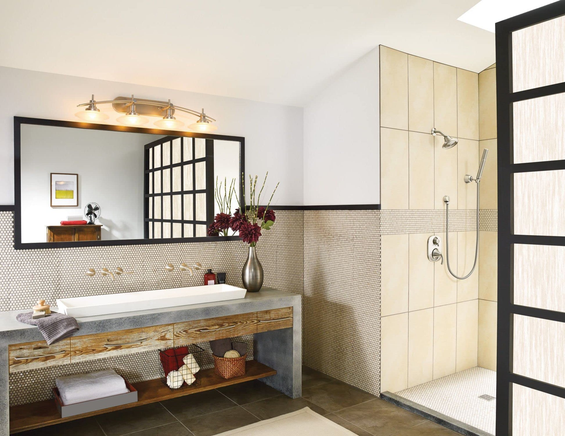 Brushed nickel handheld showerhead with wall bracket and hose installed in shower enclosure.