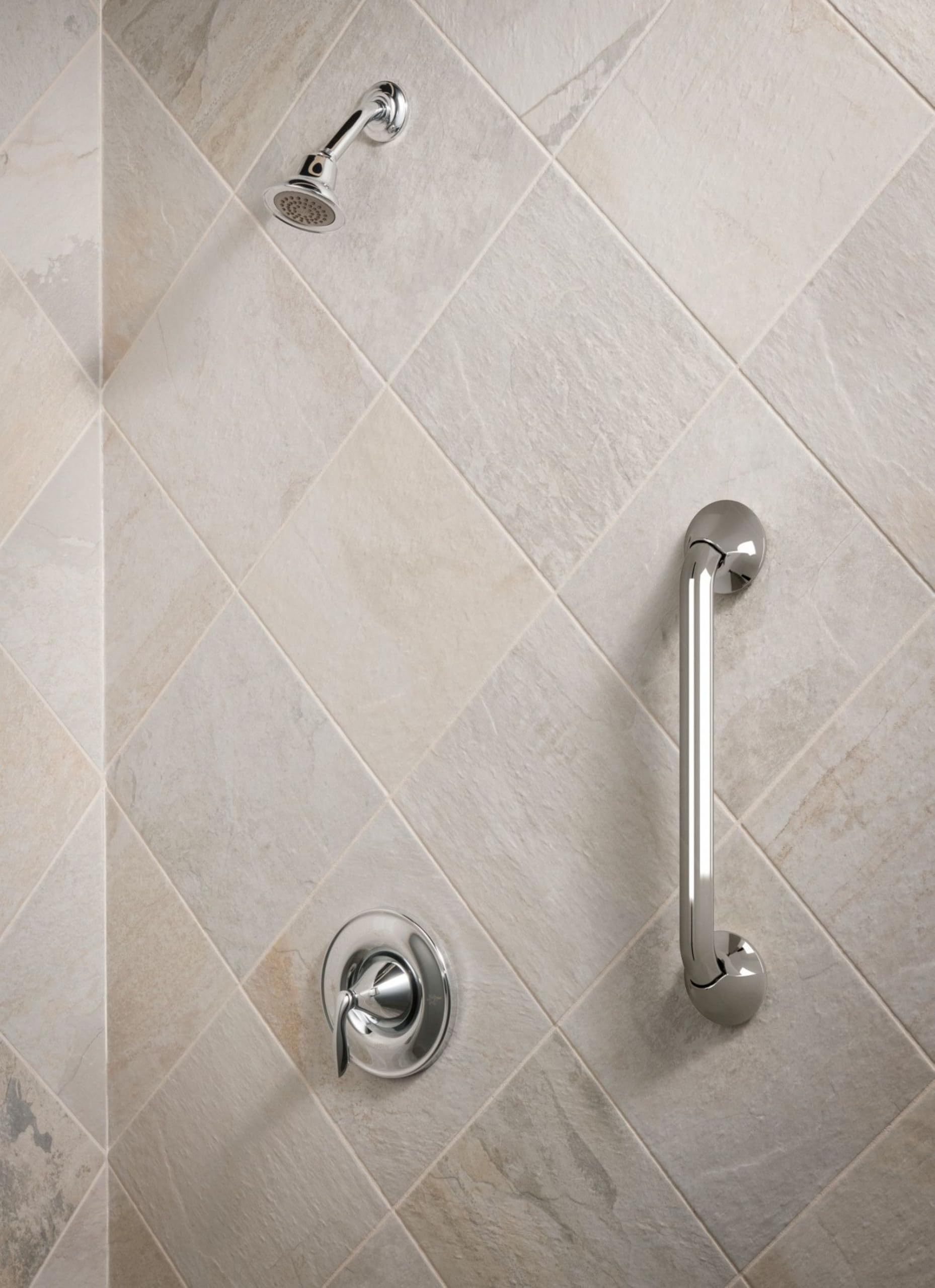 Chrome grab bar mounted vertically on tiled shower wall next to showerhead and controls.