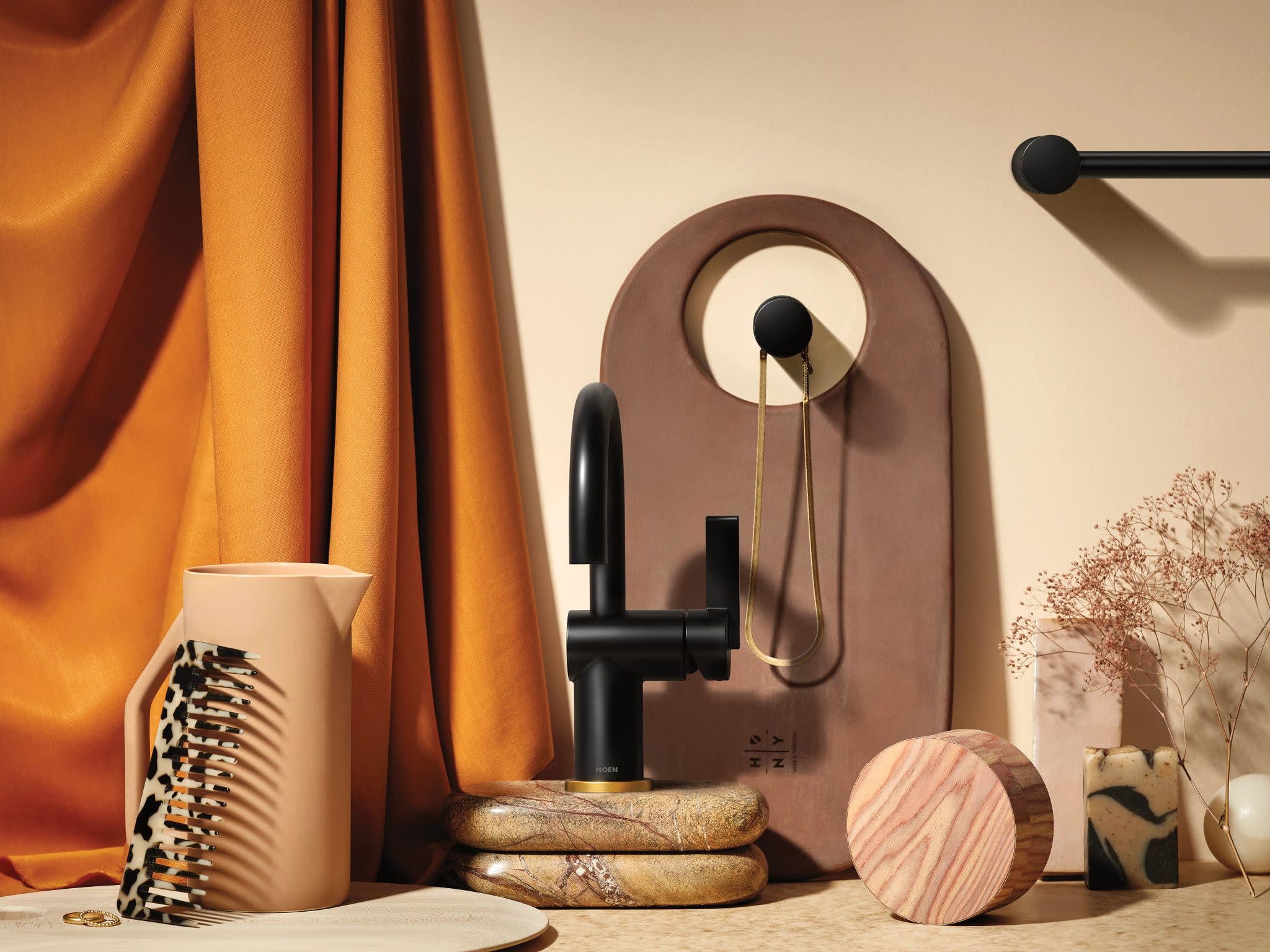 Matte black single-handle bathroom faucet with curved spout and included deckplate on display.
