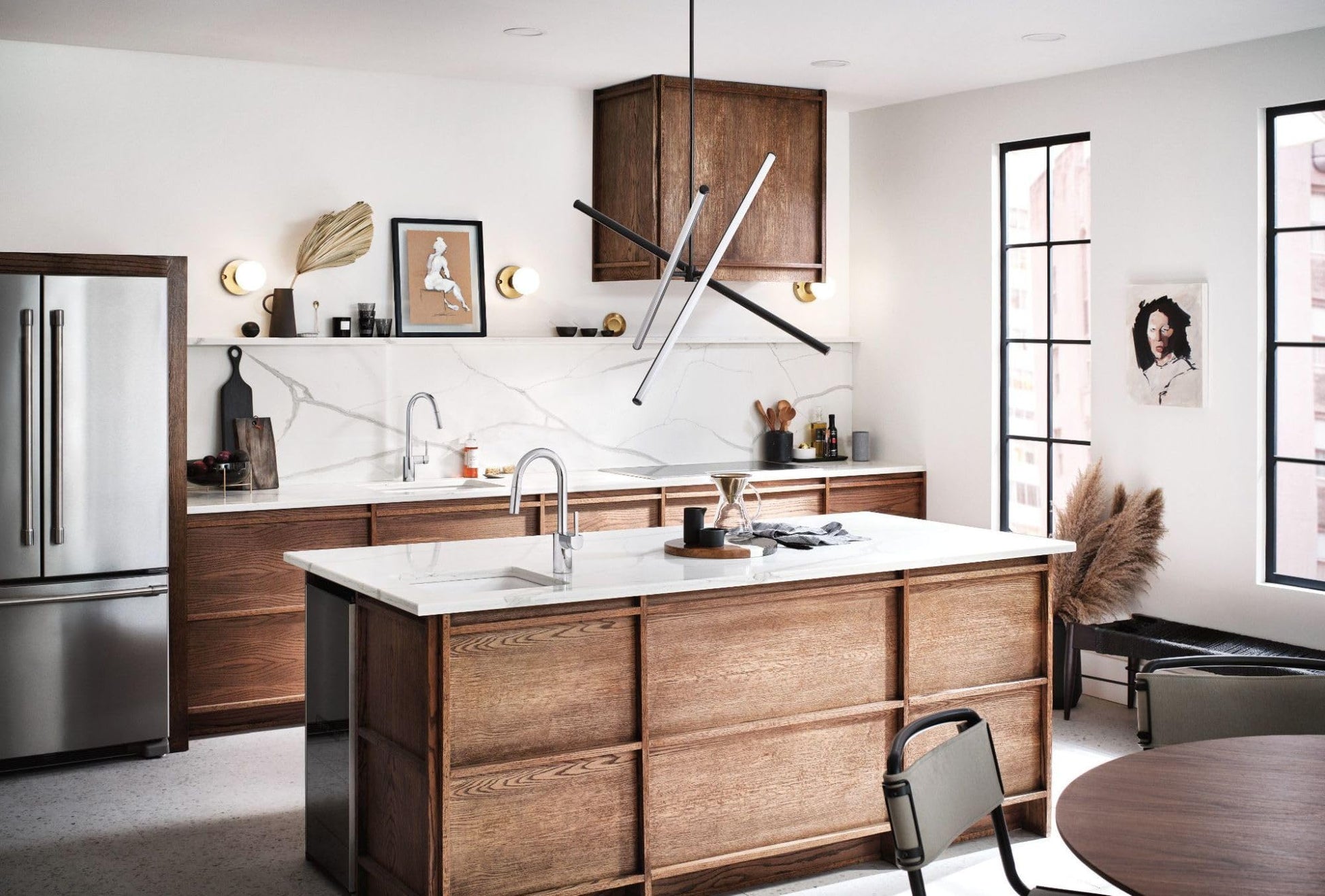 Chrome single-handle pulldown faucet with retractable spray head mounted on kitchen island sink.