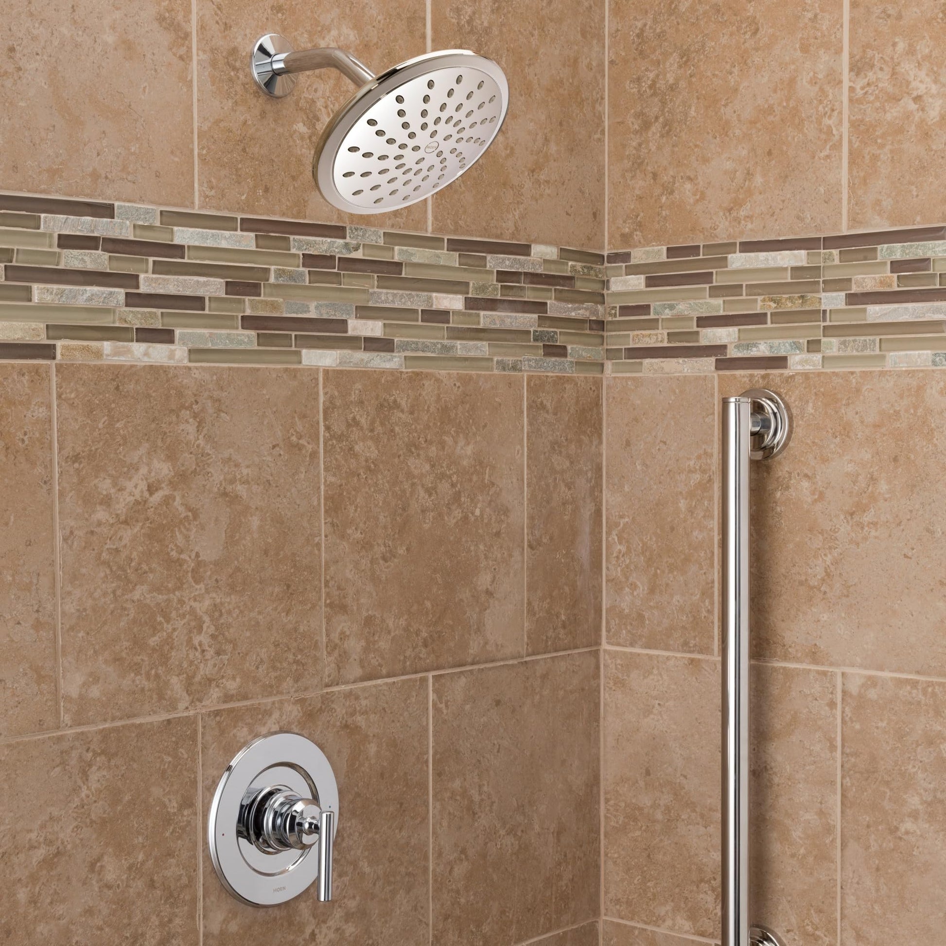Chrome shower trim kit with single handle, round showerhead, and valve mounted on tiled shower wall.