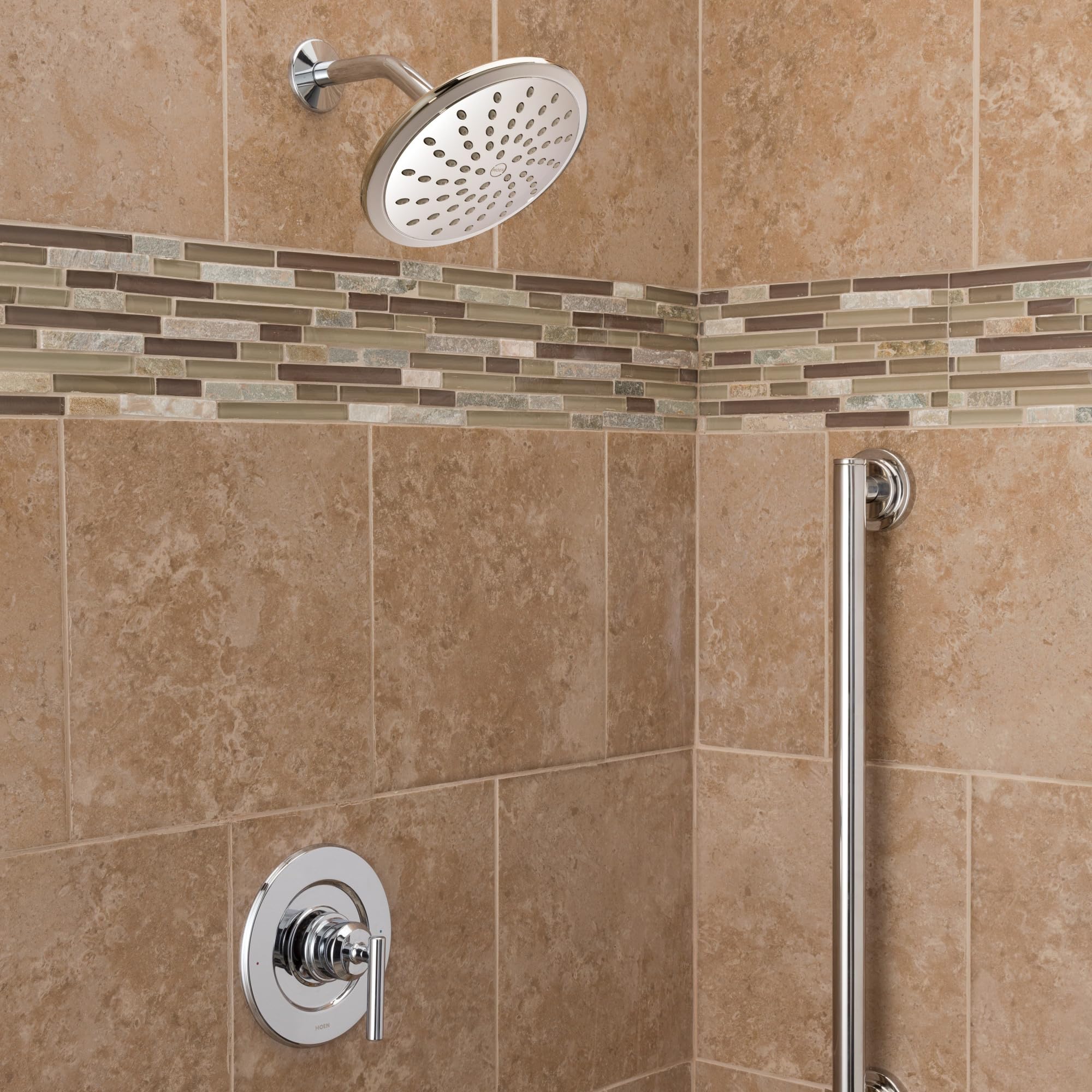 Chrome shower trim kit with single handle, round showerhead, and valve mounted on tiled shower wall.