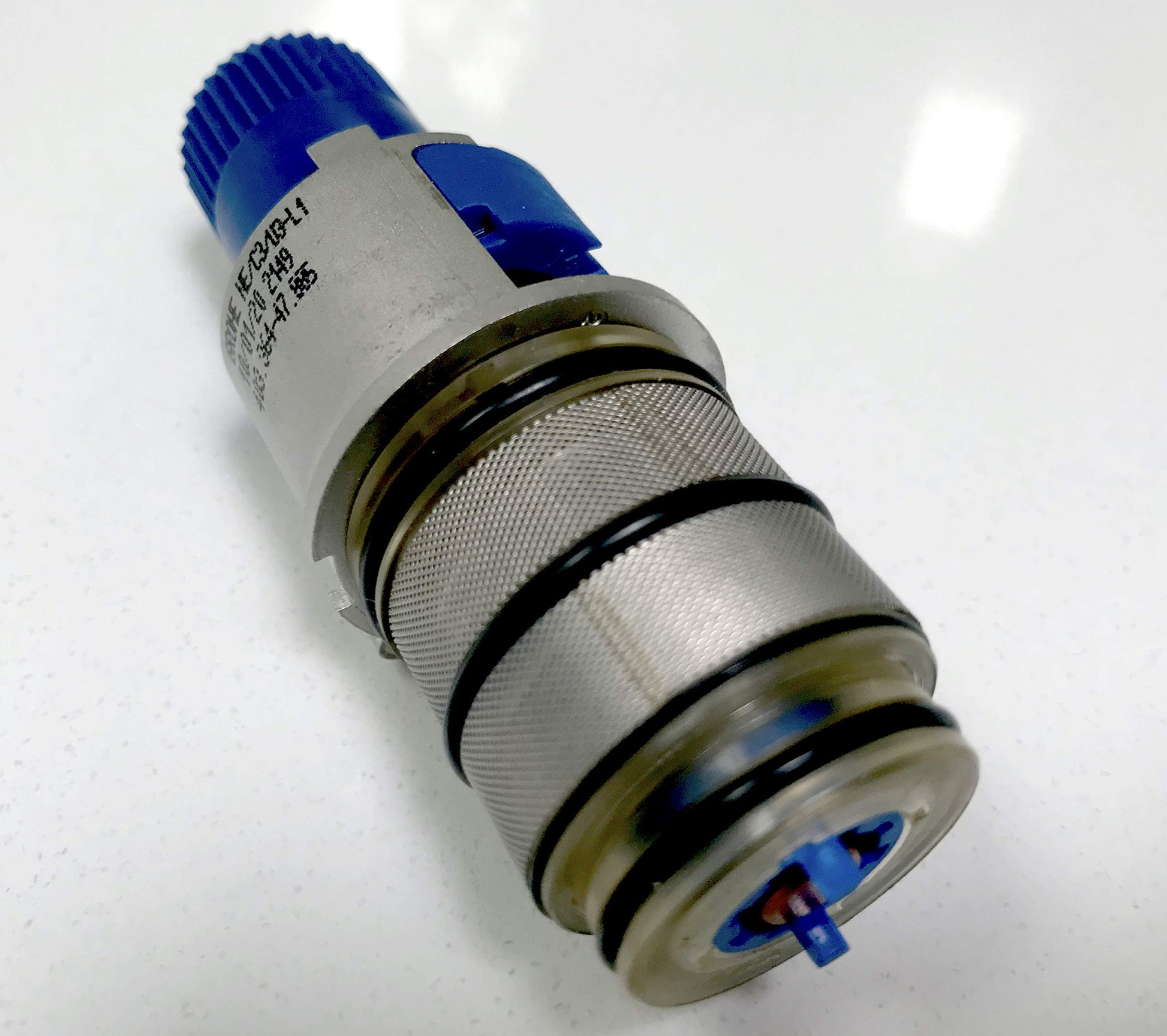 Grohe 47885000 thermostatic compact cartridge with blue grip top, chrome finish, and internal components visible.