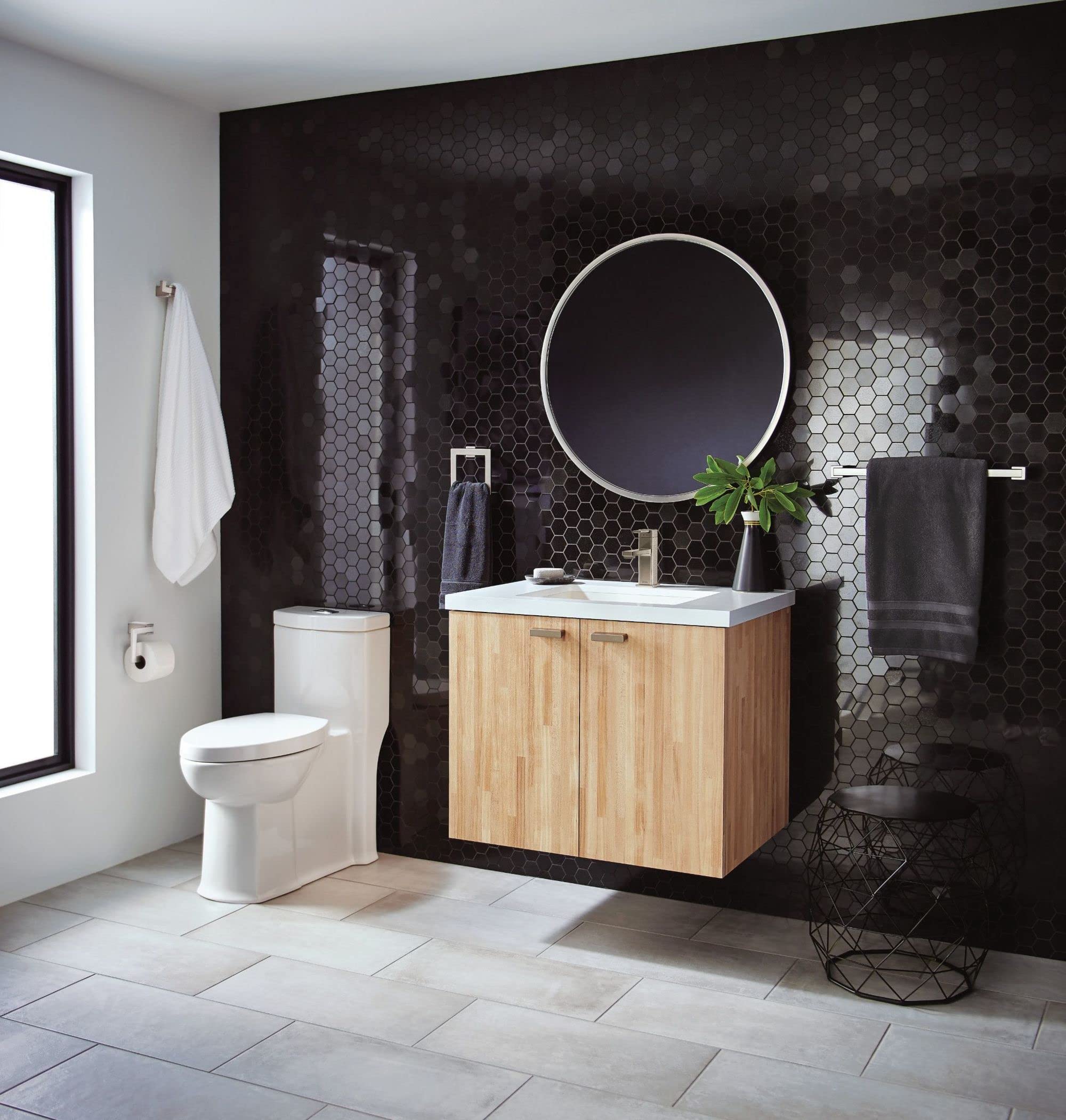 Chrome single-handle faucet with angular spout mounted on white sink in modern bathroom setting.