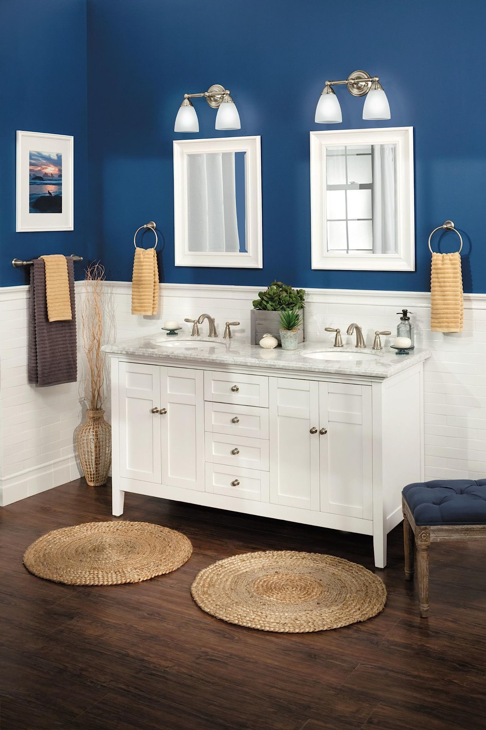 Brushed nickel wall-mount towel ring displayed on bathroom wall holding folded yellow towel.