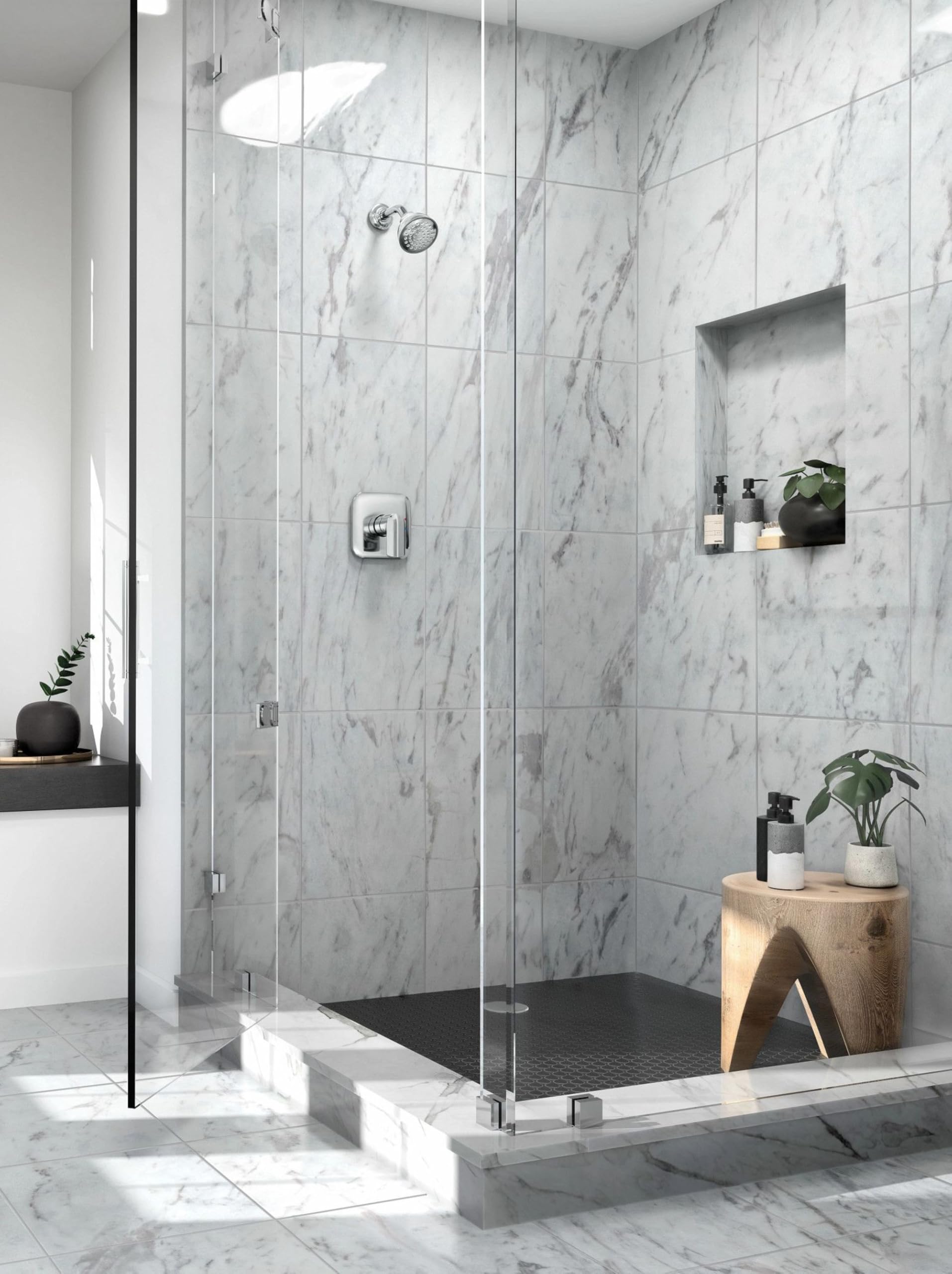 Chrome shower trim kit with single handle installed on marble tile wall inside glass enclosure.