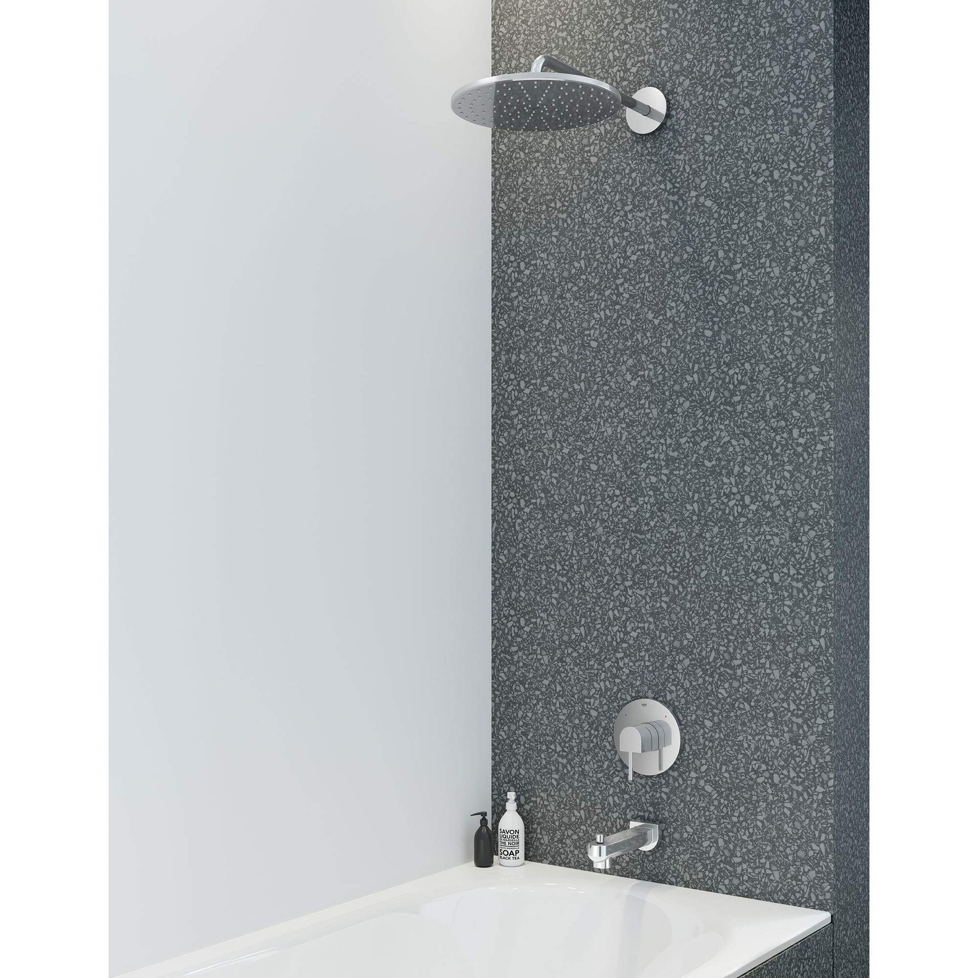 Chrome shower valve trim with round showerhead and single control knob mounted on tile wall above bathtub.